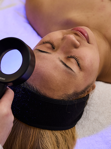 St. Skin skin clinician performing a skin extraction as part of holistic treatment.