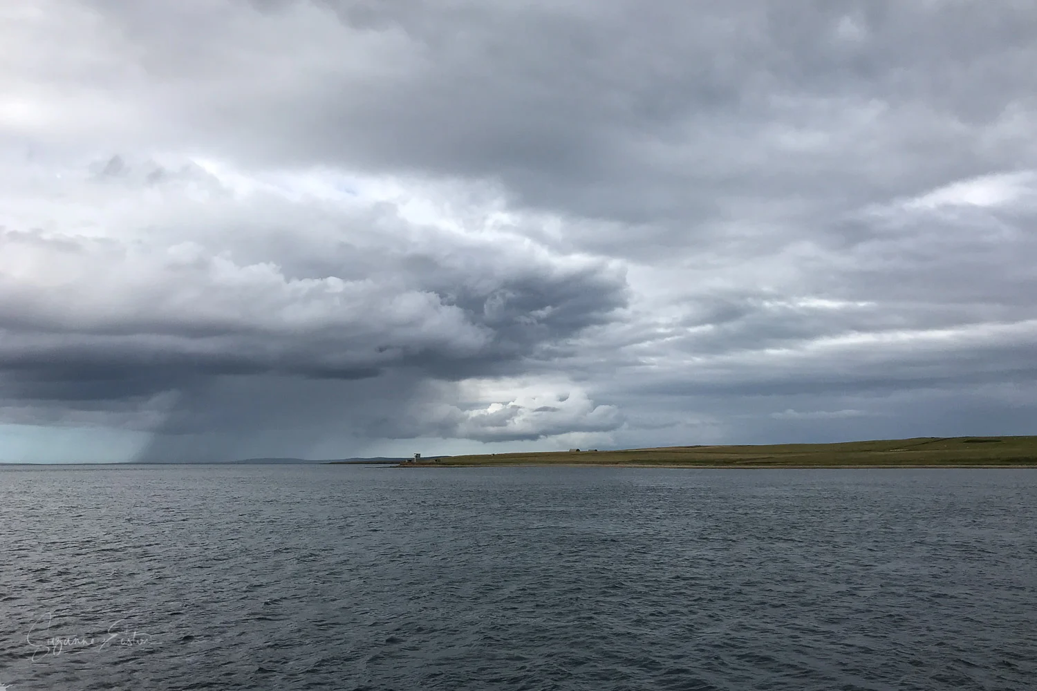 Eday and Sanday in a rain shower from the ferry