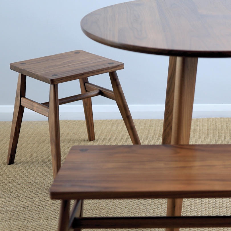 Handcrafted wooden dining furniture, rounmd table and stools made in solid walnut wood. 
