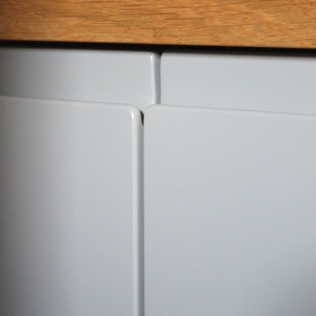 Tailor made sideboard in a hallway with a solid oak top and grey painted doors.