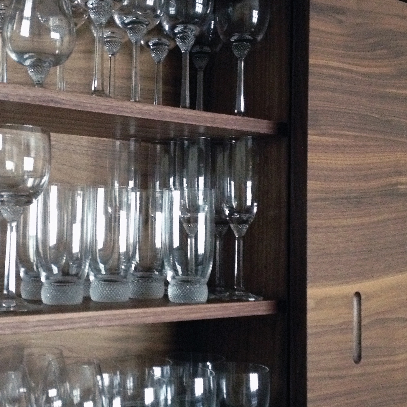 Drinks cabinet or home bar custom made in walnut including shelving for glassware.