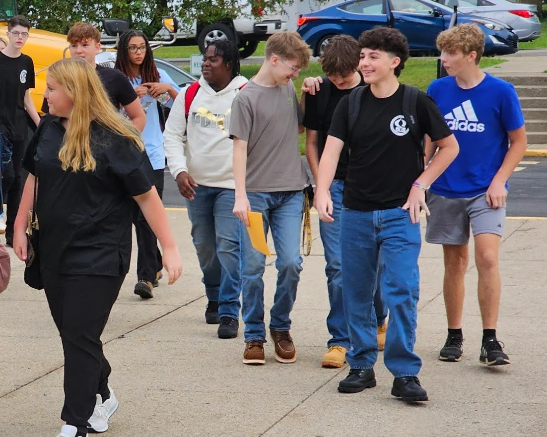 Students exit the busses and head into the school — ready for a great year!