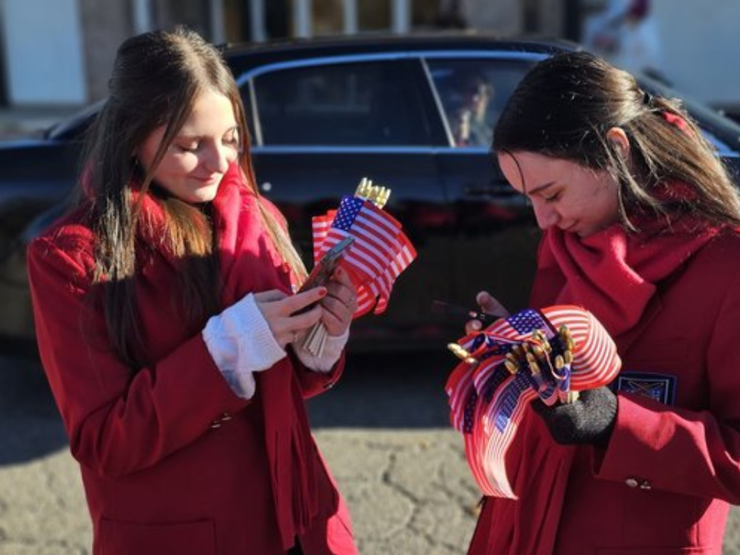 Distributing flags with Agent Orange Veterans at the Veterans Day Parade