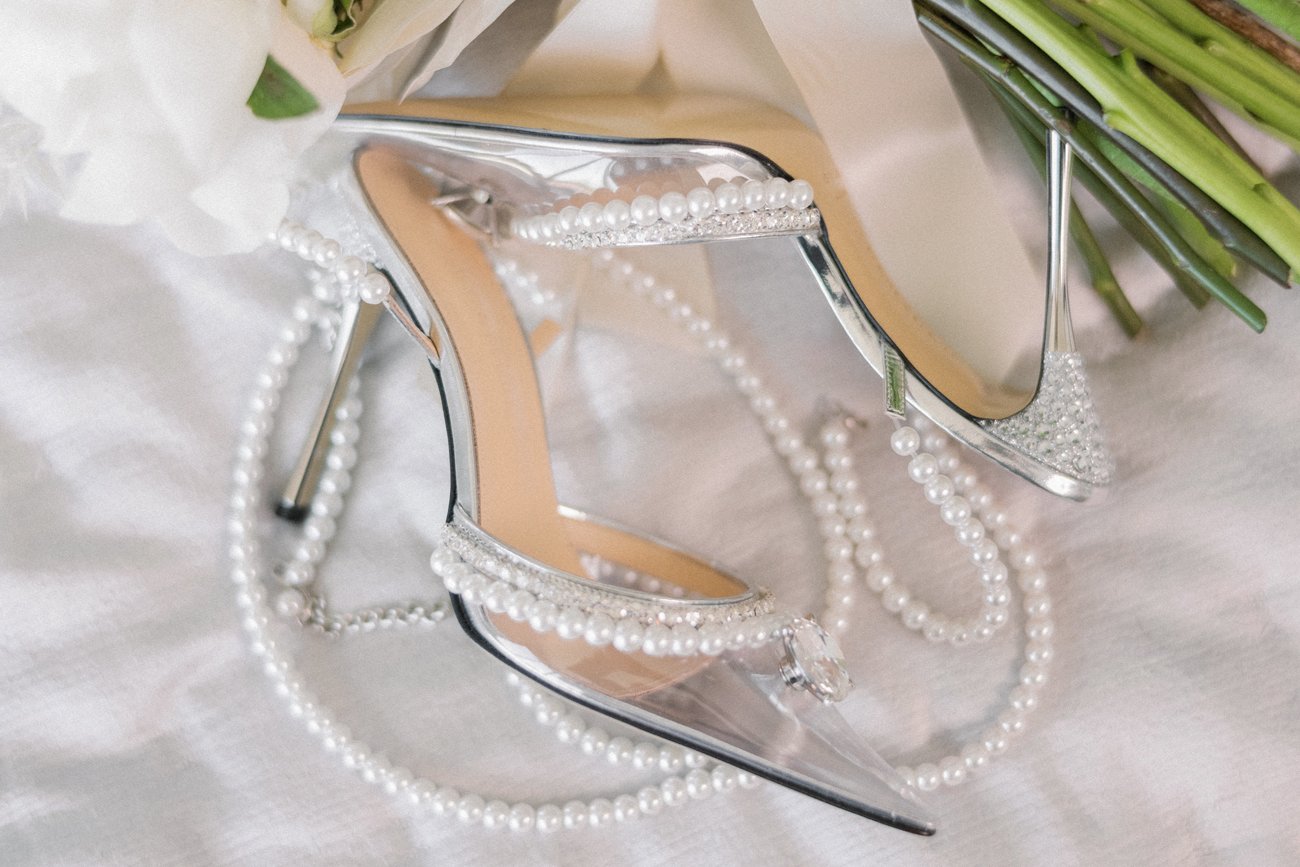Wedding accessories: bridal shoes on high heels, jewelry for bride, groom's  shoes, bow tie, bouquet of flowers and wedding rings on vintage wooden  background Stock Photo | Adobe Stock