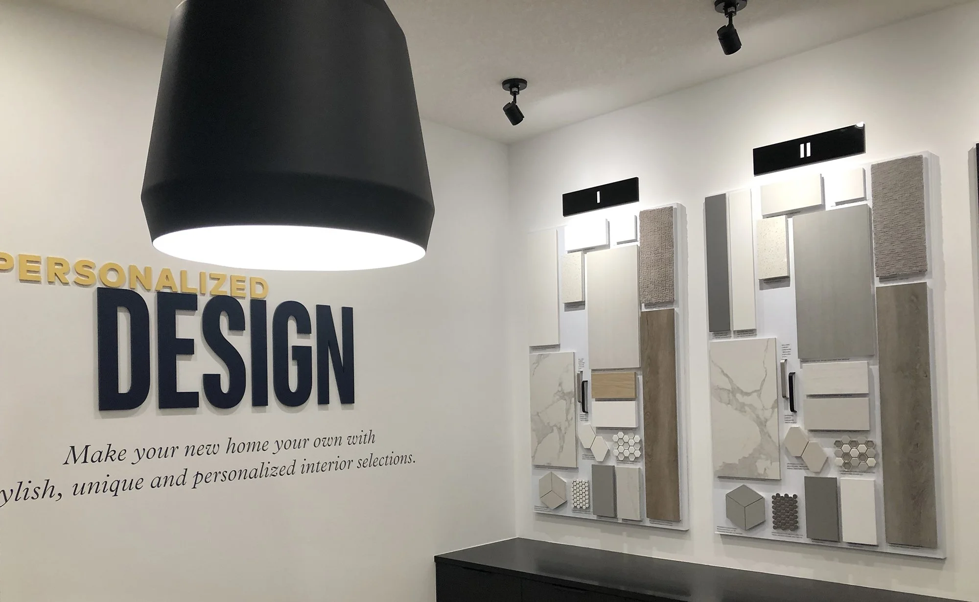 Dimensional type, vinyl graphic, sample boards and signage above