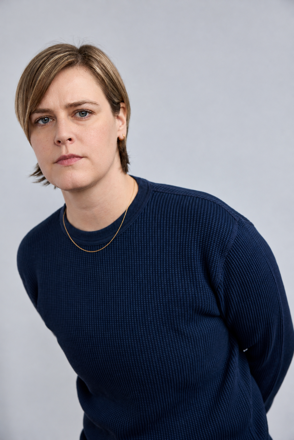 Minimalist Studio Portrait with Gold Jewelry.png