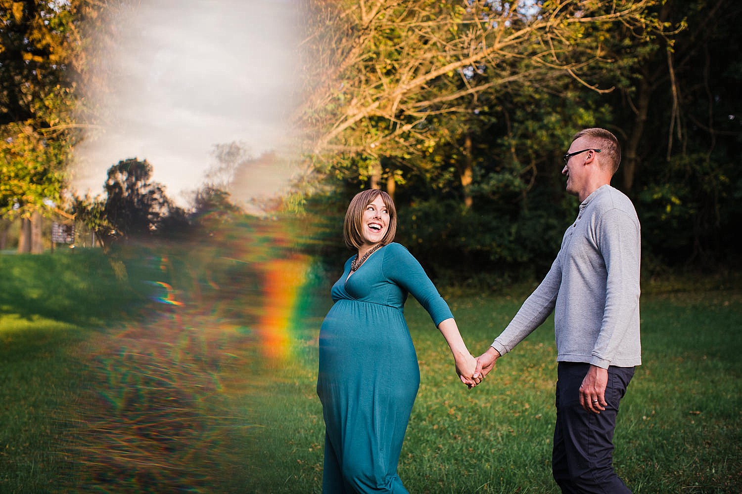  Photo of a pregnant woman and her husband walking down a path hand in hand. 