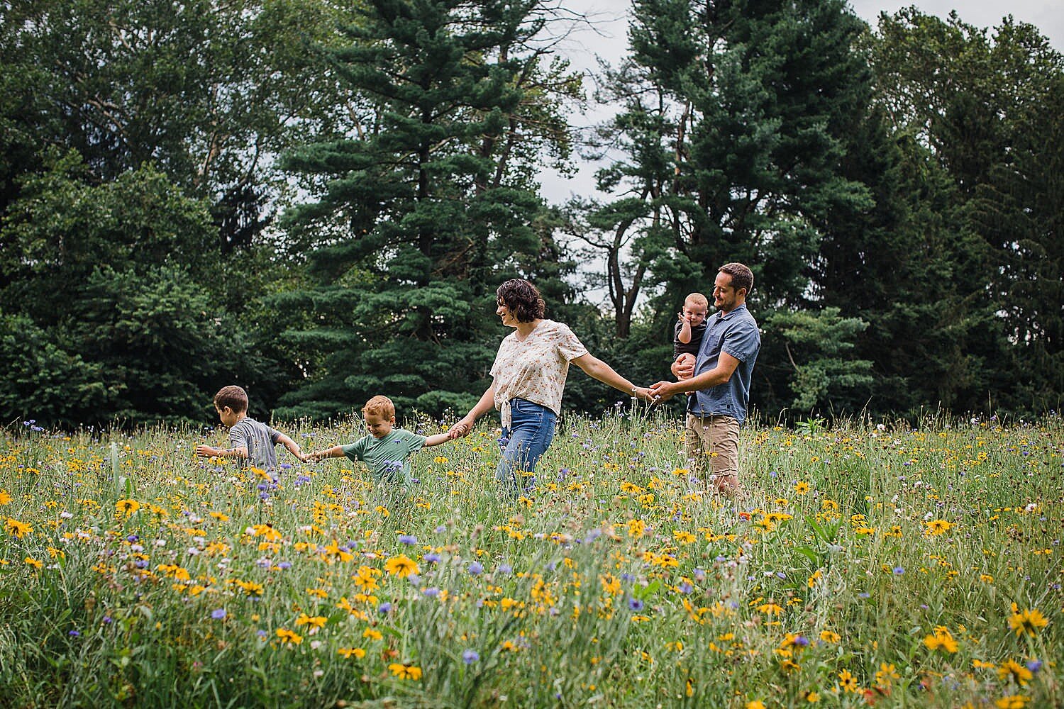 Colorful summer family in a wildflower field