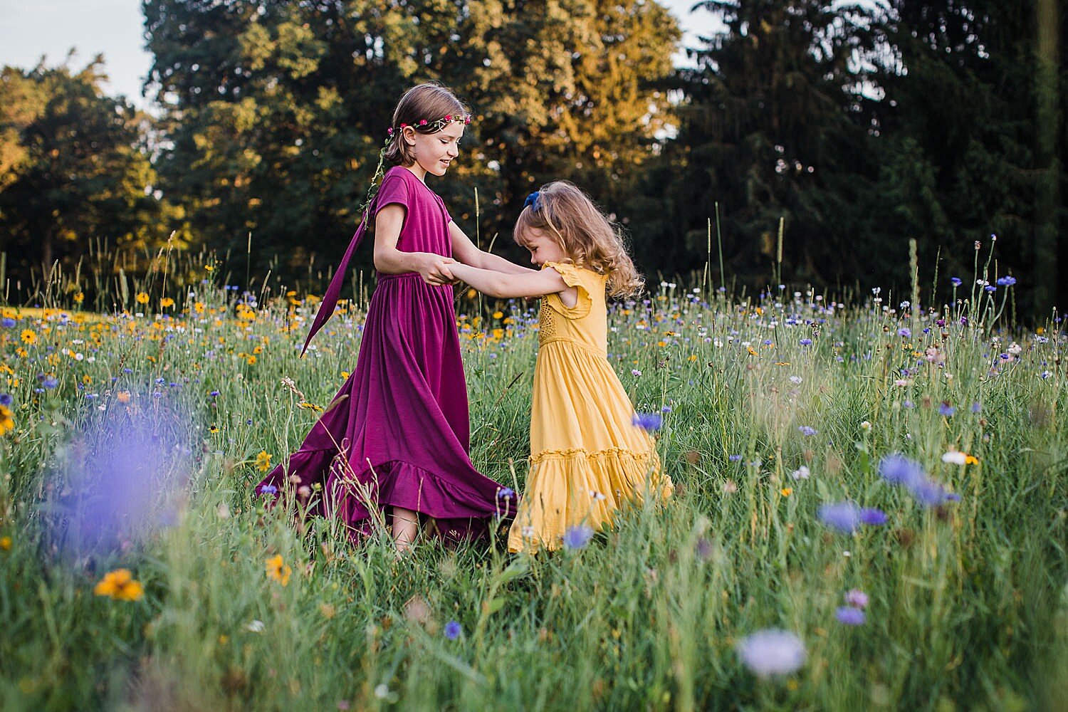 Colorful summer girls in a wildflower field