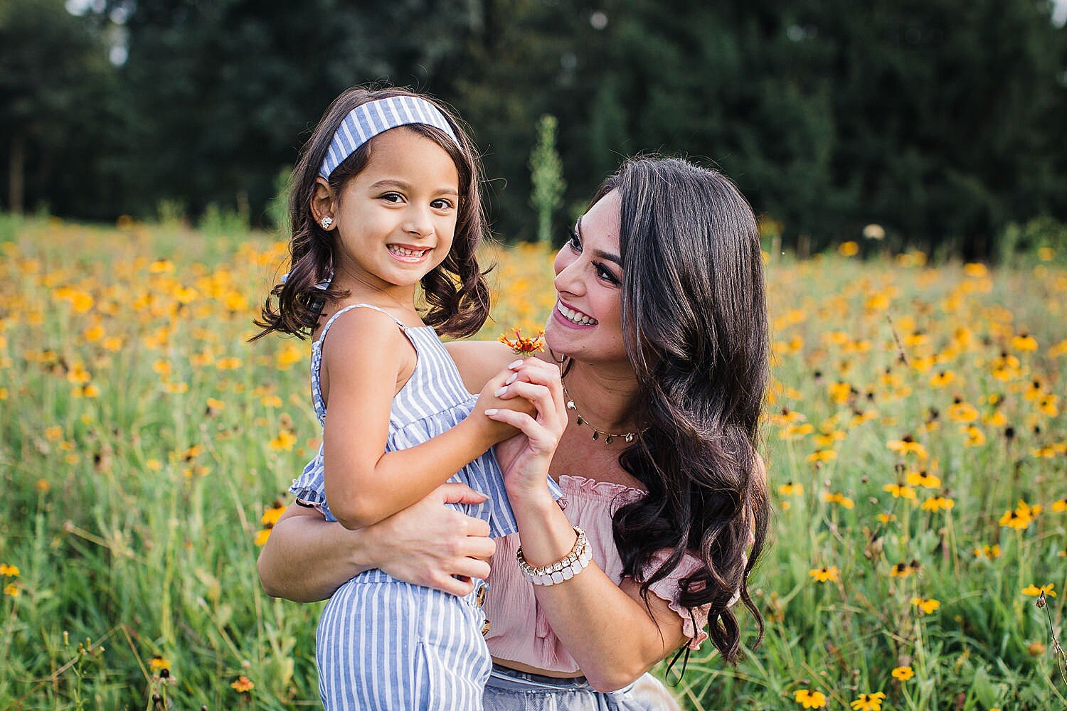 mother and daughter in a wildflower field