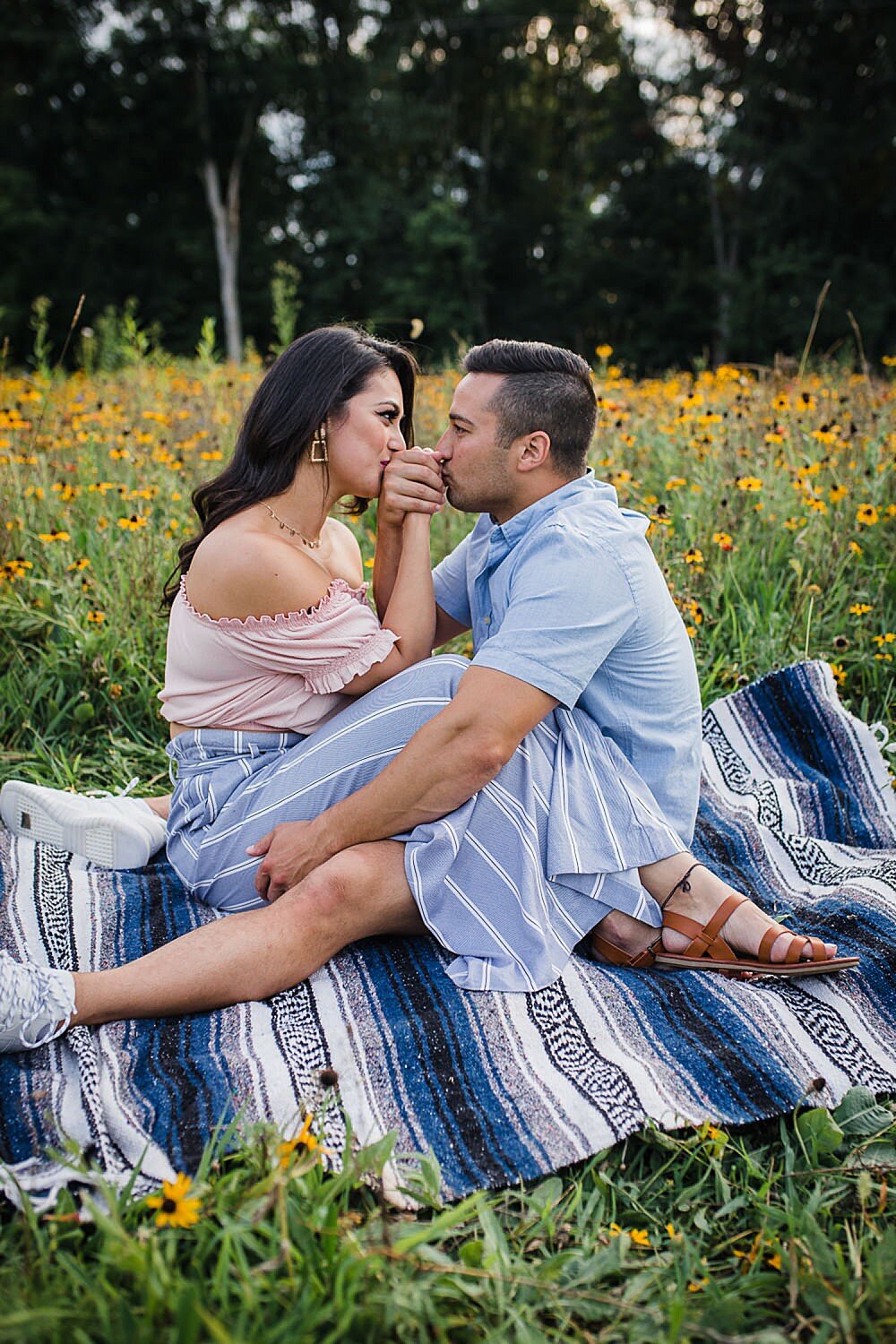 couple on a blanket in a wildflower field