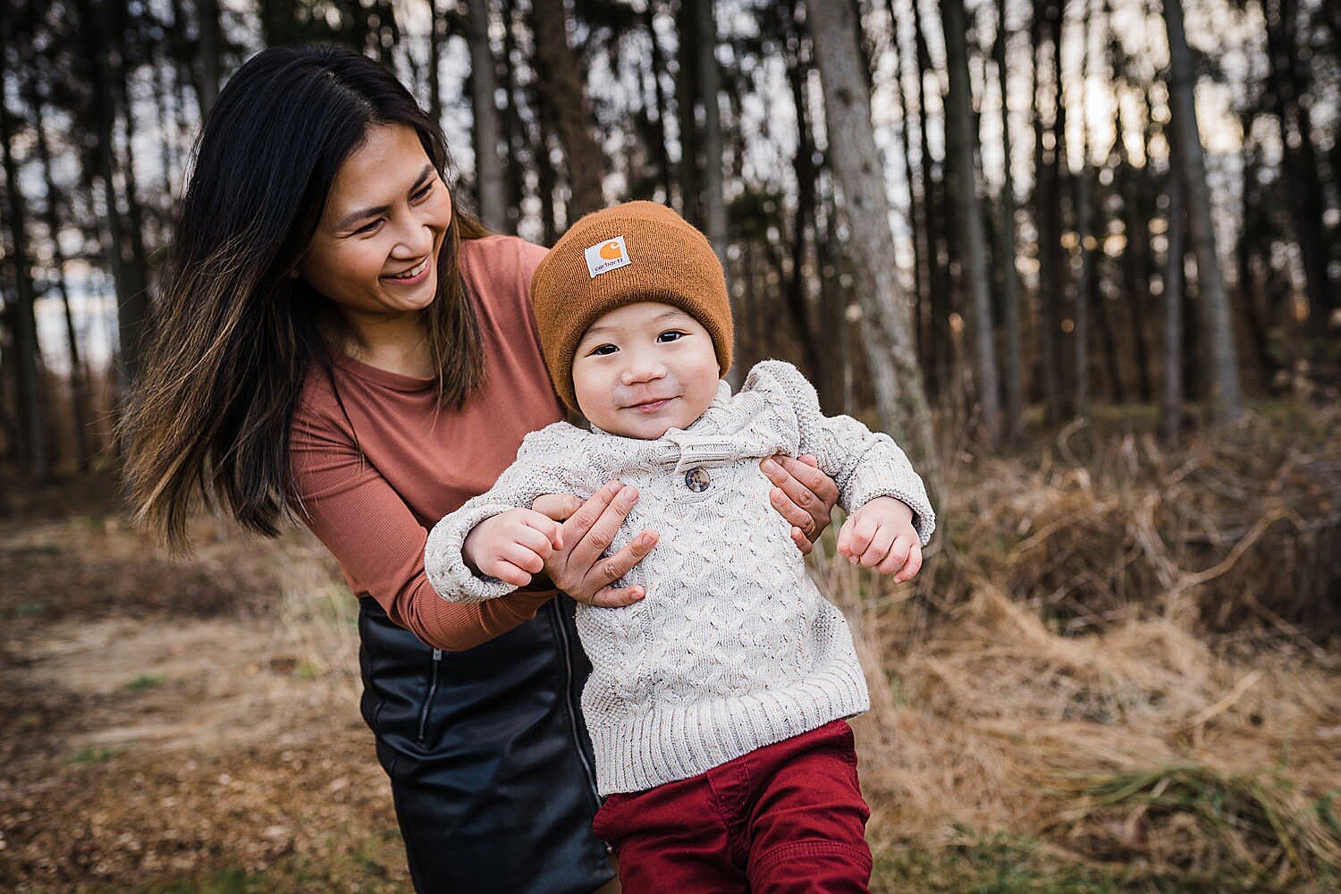  Asian mother swinging her little boy in the air. 