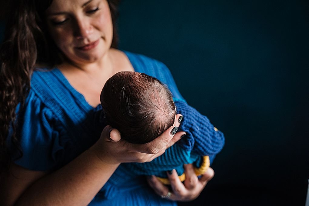 mother holds newborn son