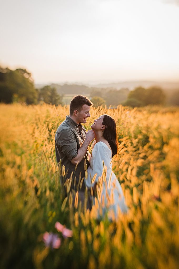 couple in a field at sunset