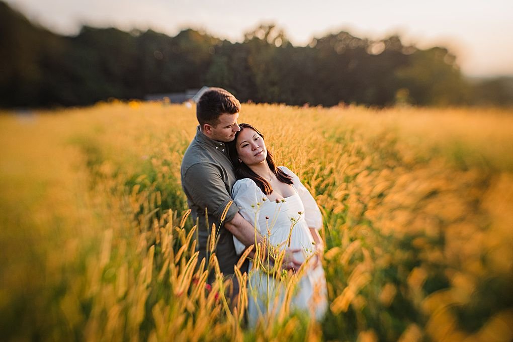 Couple in a golden field at sunset