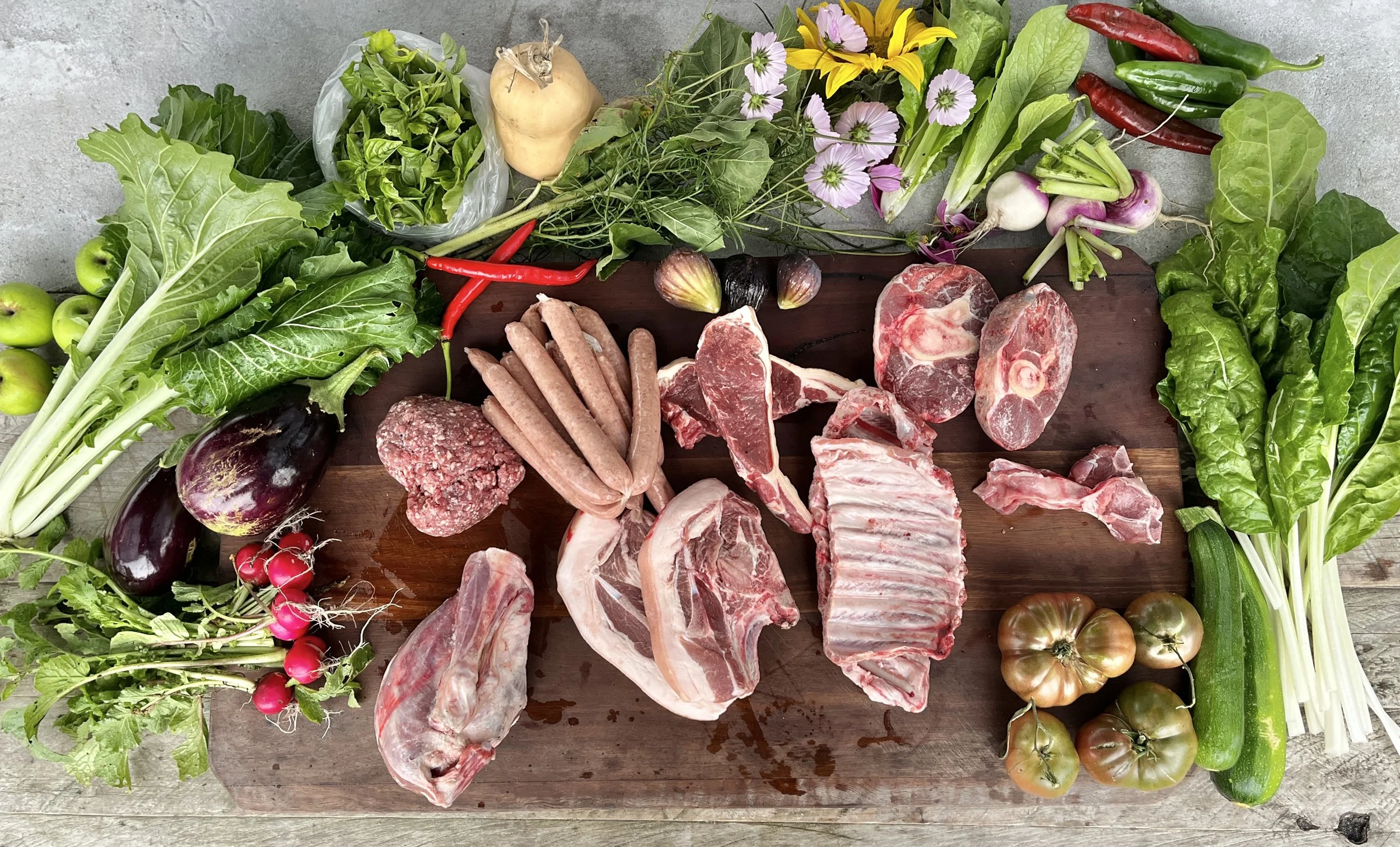 An array of vegetables and meat laid out on a table