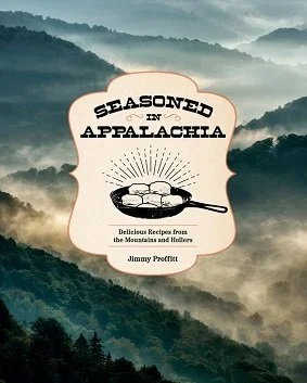 Title of book for Seasoned in Appalachia by Jimmy Proffitt. The title is above a skillet of biscuits, which is against a background of mountains with a mist over them.