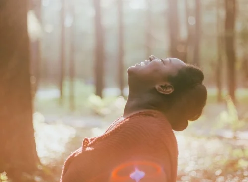 a woman in a forest looking up and loving it.jpg