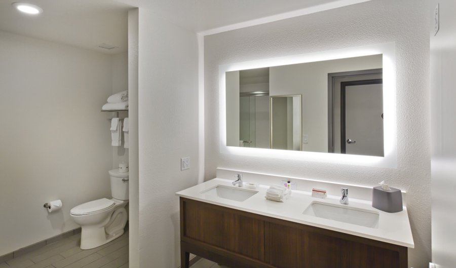 Bathrooms at Holiday Inn Hotel Design in Glendale, AZ - Hotel Architect