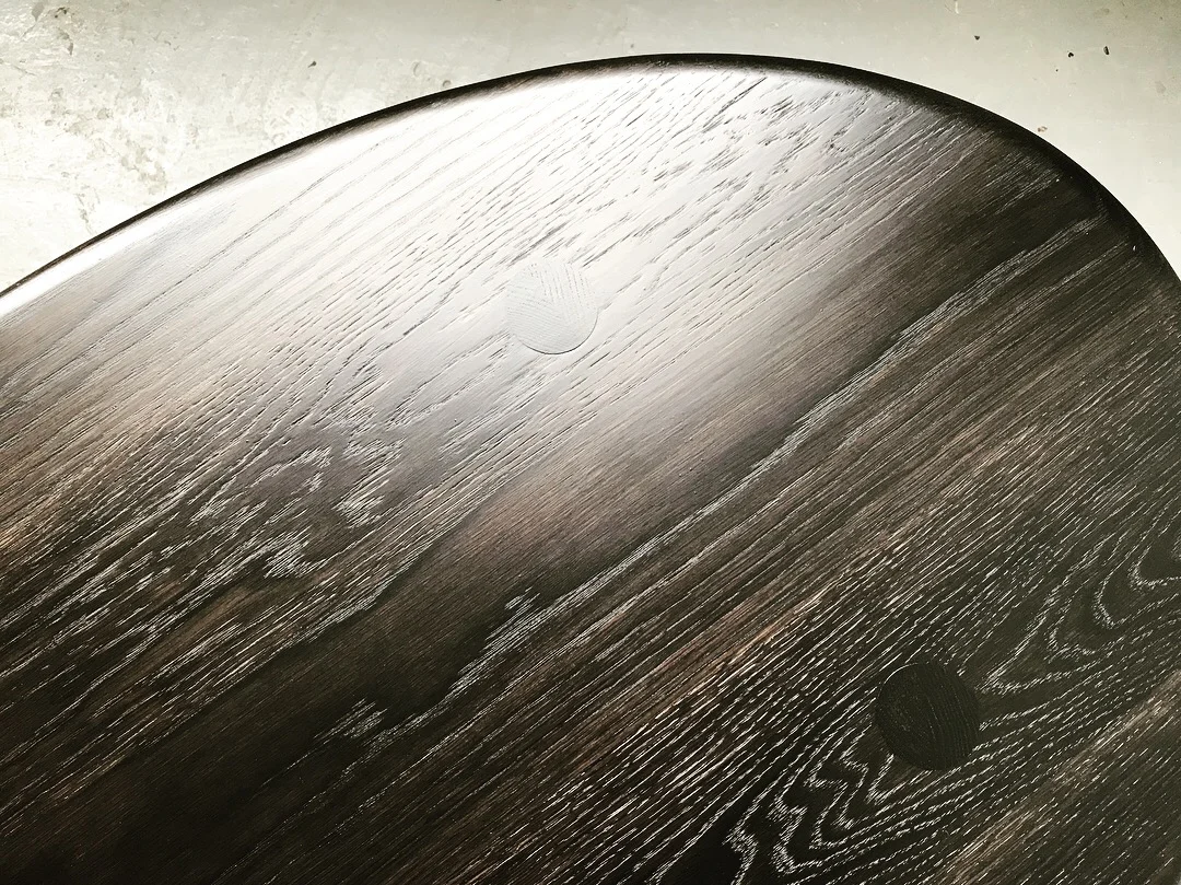  The tops of the legs are exposed in the surface of the table for a little construction legibility, and the edge profile is shallow and smooth like a good beach pebble. 