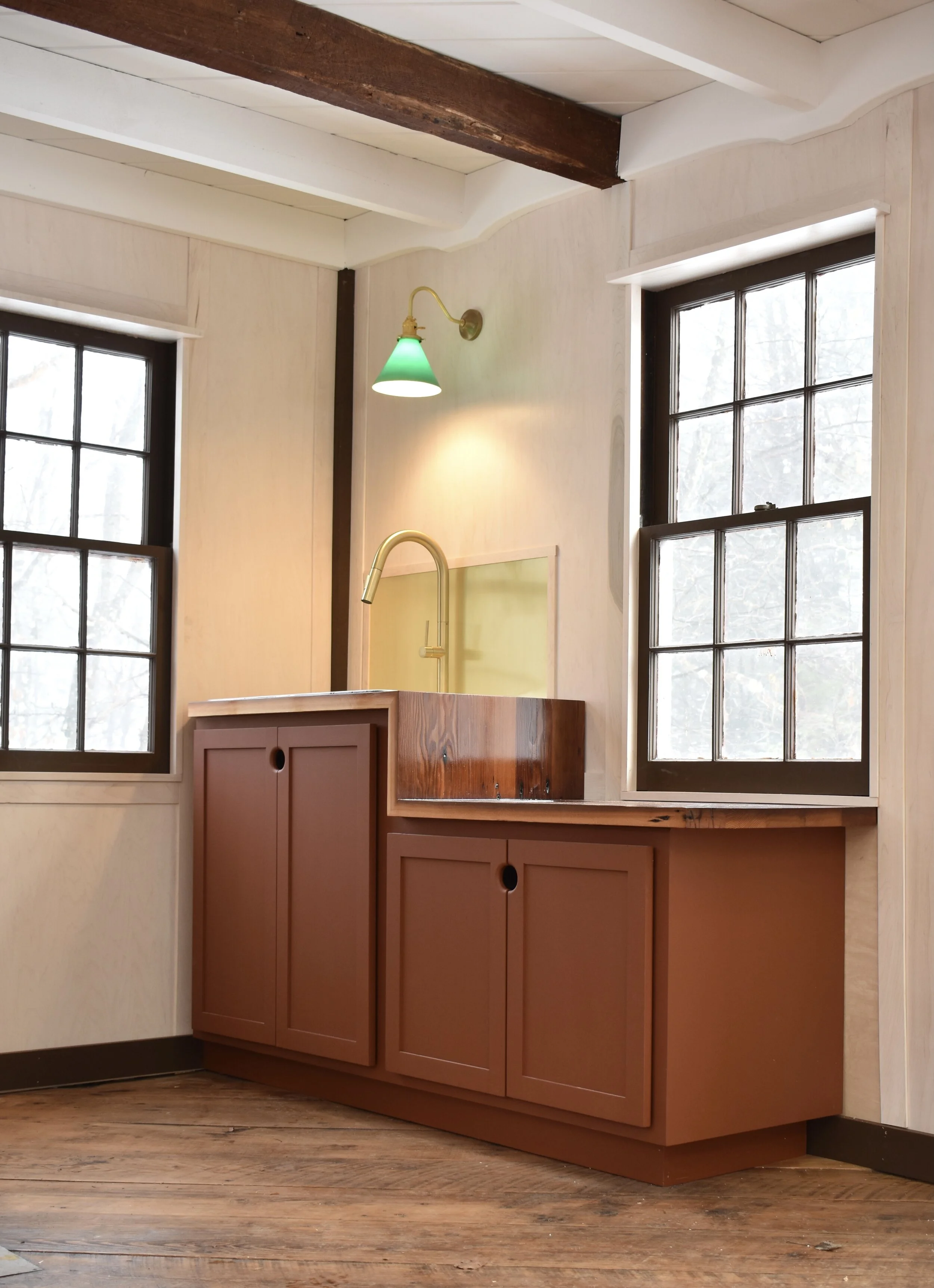  Sink with sidecar drainboard. The waterfall top is made of reclaimed Douglas Fir flooring. Custom cabinetry. Brass fixtures and backsplash. 