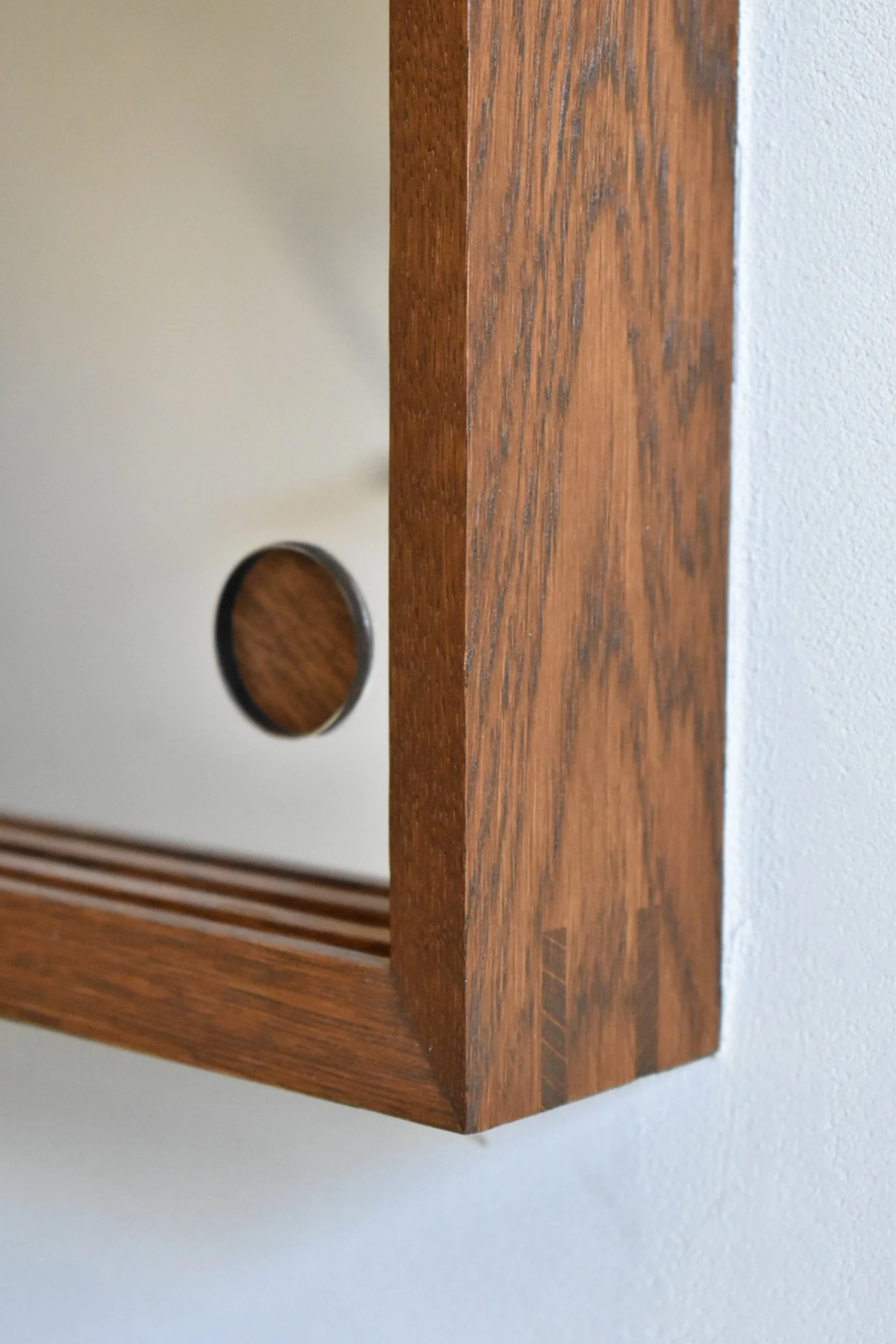  Miter splined cases are partially inset in the wall via a rabbeted case side.  