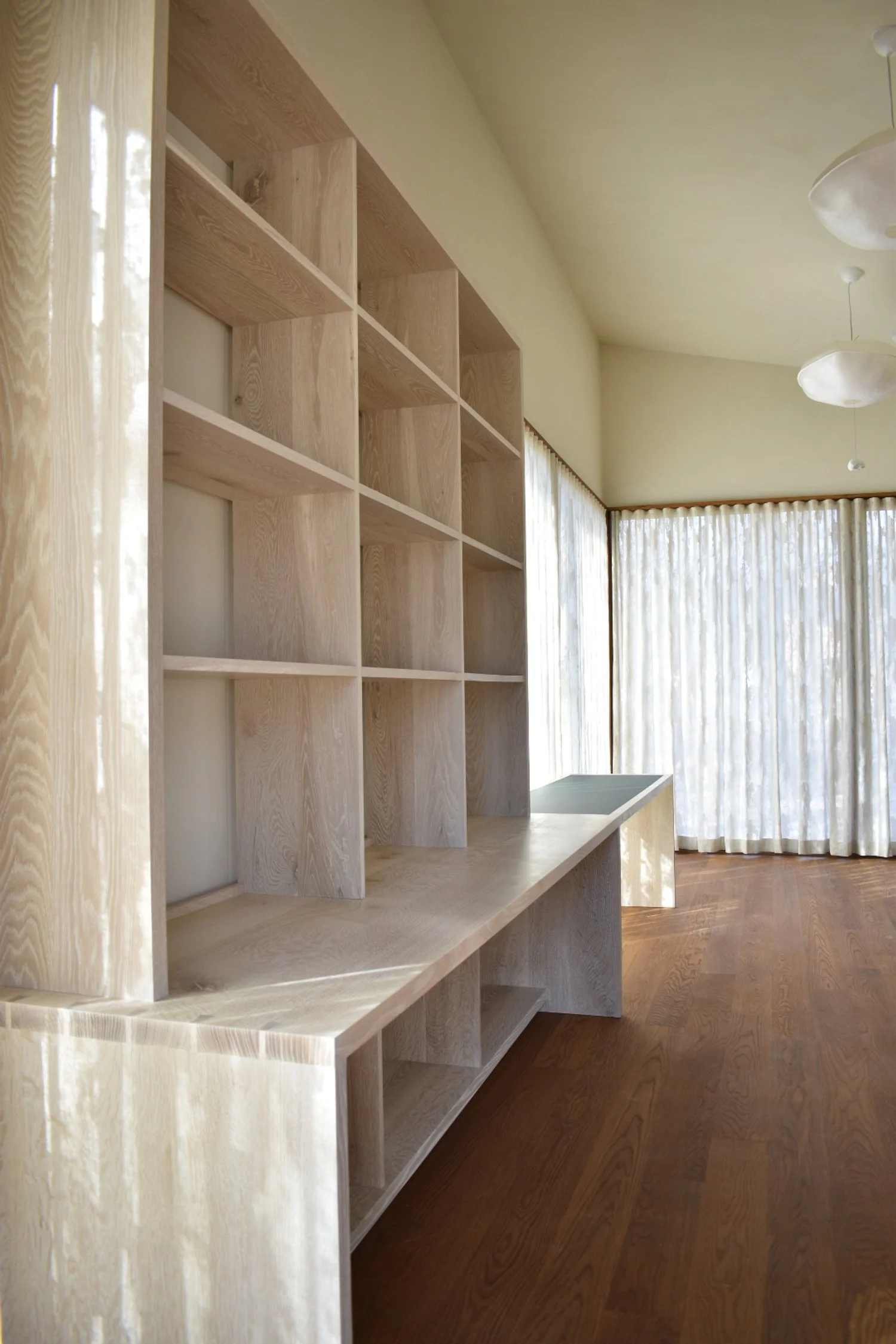  The lower unit is made of quartersawn white oak to limit seasonal change in the fit of the linoleum panel. The panel is inset and attached with slotted screw channels underneath to allow for wood movement around it.  