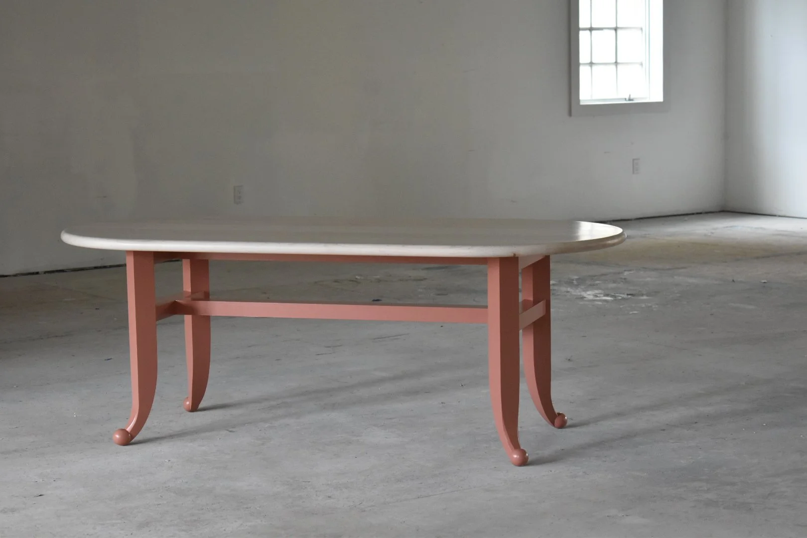  A trestle base provides roomy and approachable seating. 