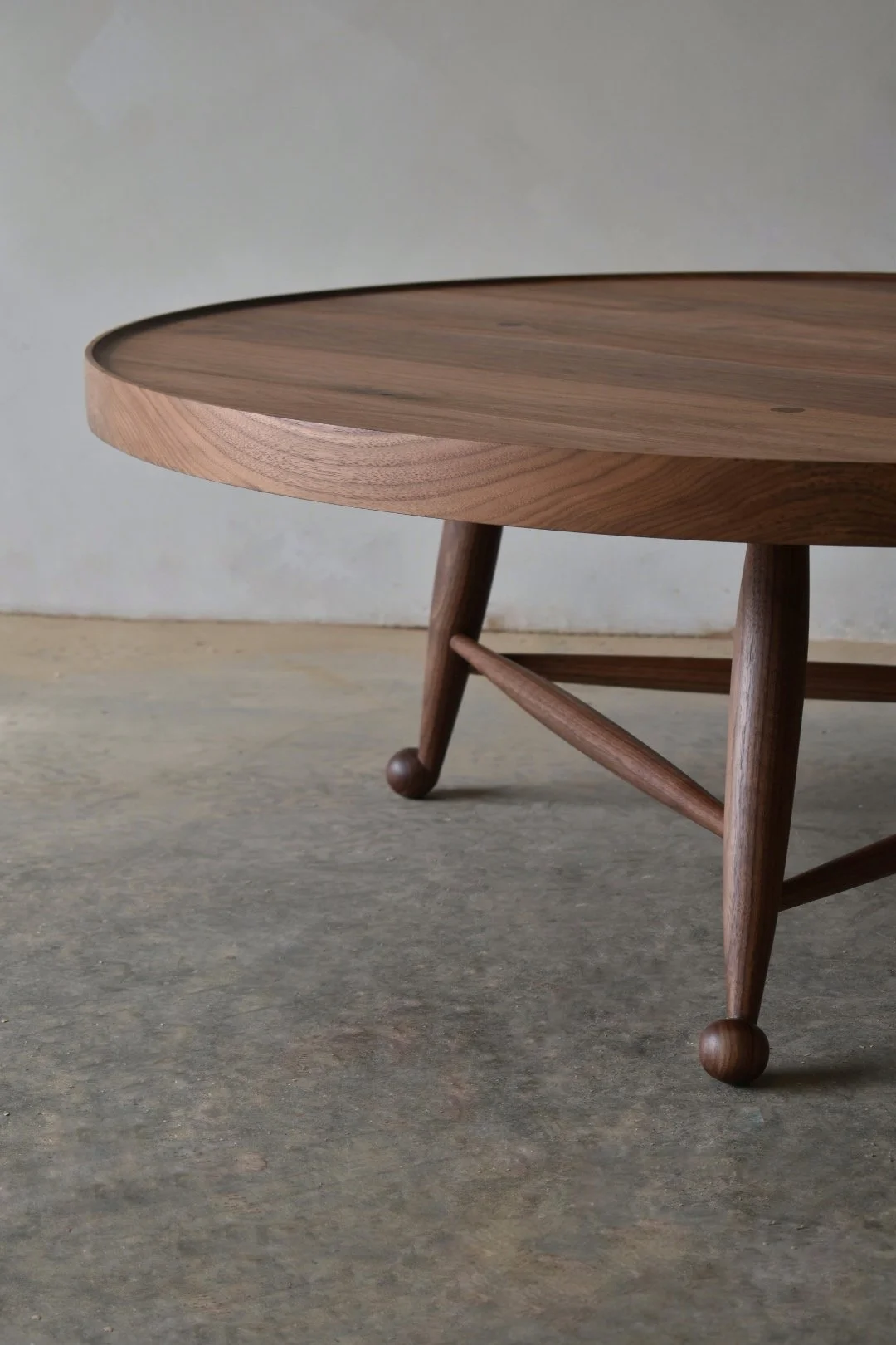  Turned legs resolve into hand-carved ball feet and have tapered through-tenons for strength and legibility.  