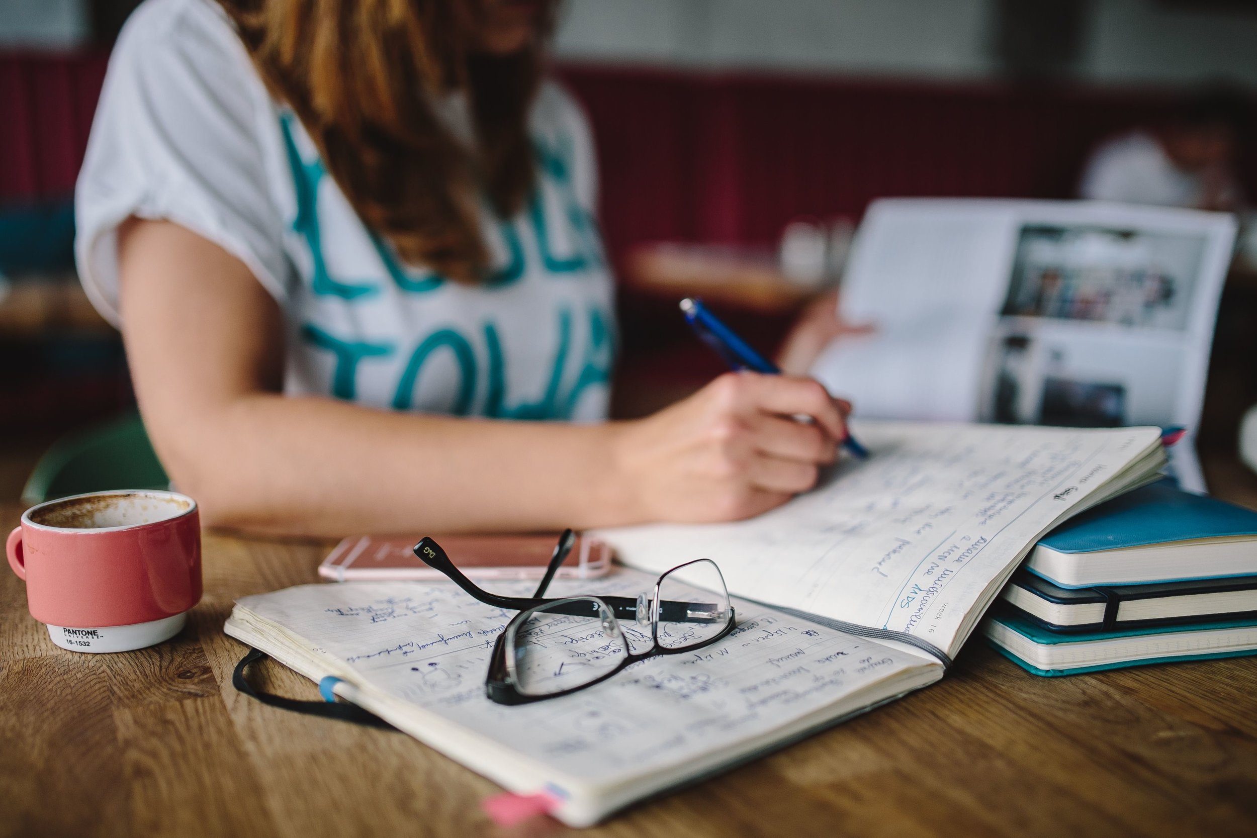 kaboompics_Woman writing in her notebook.jpg