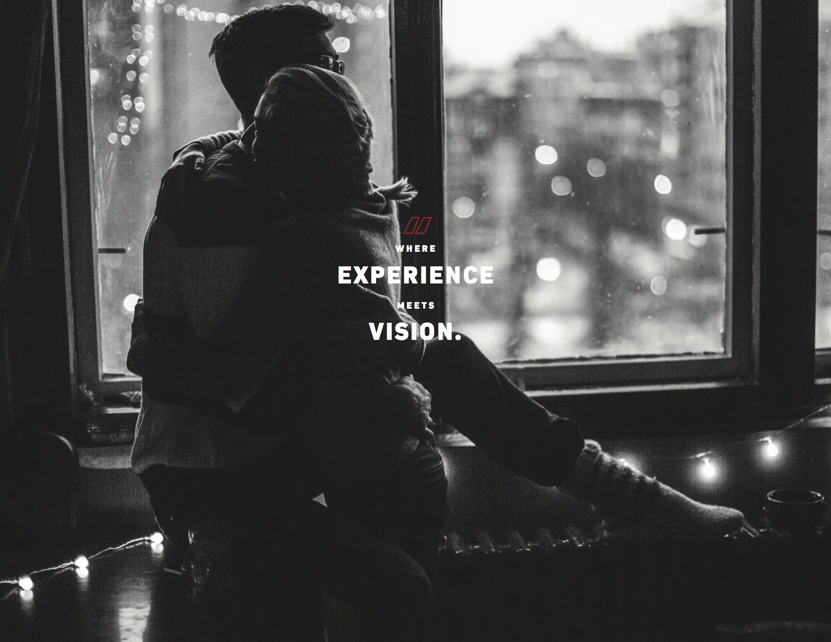Black and white image of a man and woman hugging, with the tagline, "Where experience meets vision."