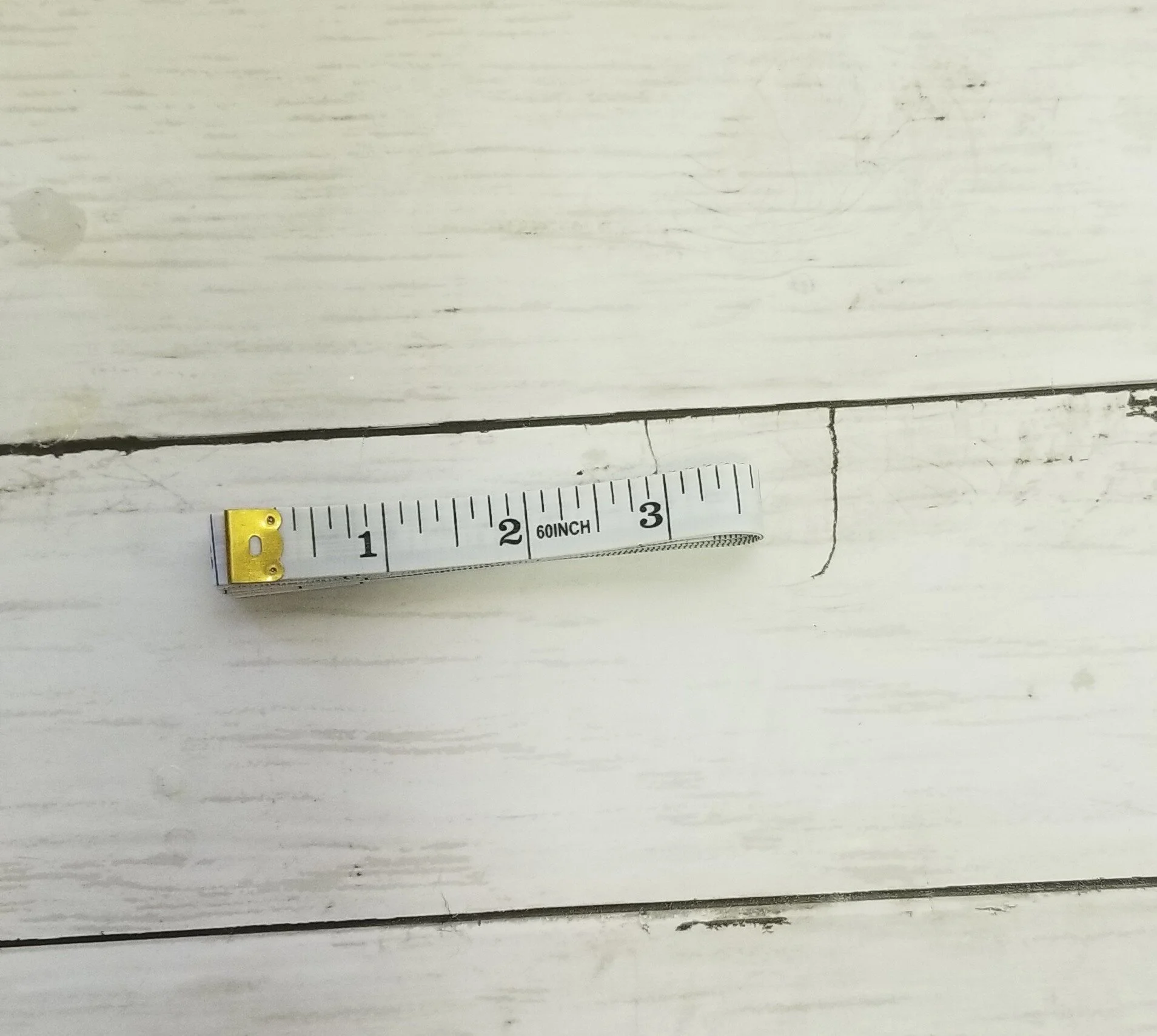 Cropped white tape measure_folded_www.guchet.com.jpg