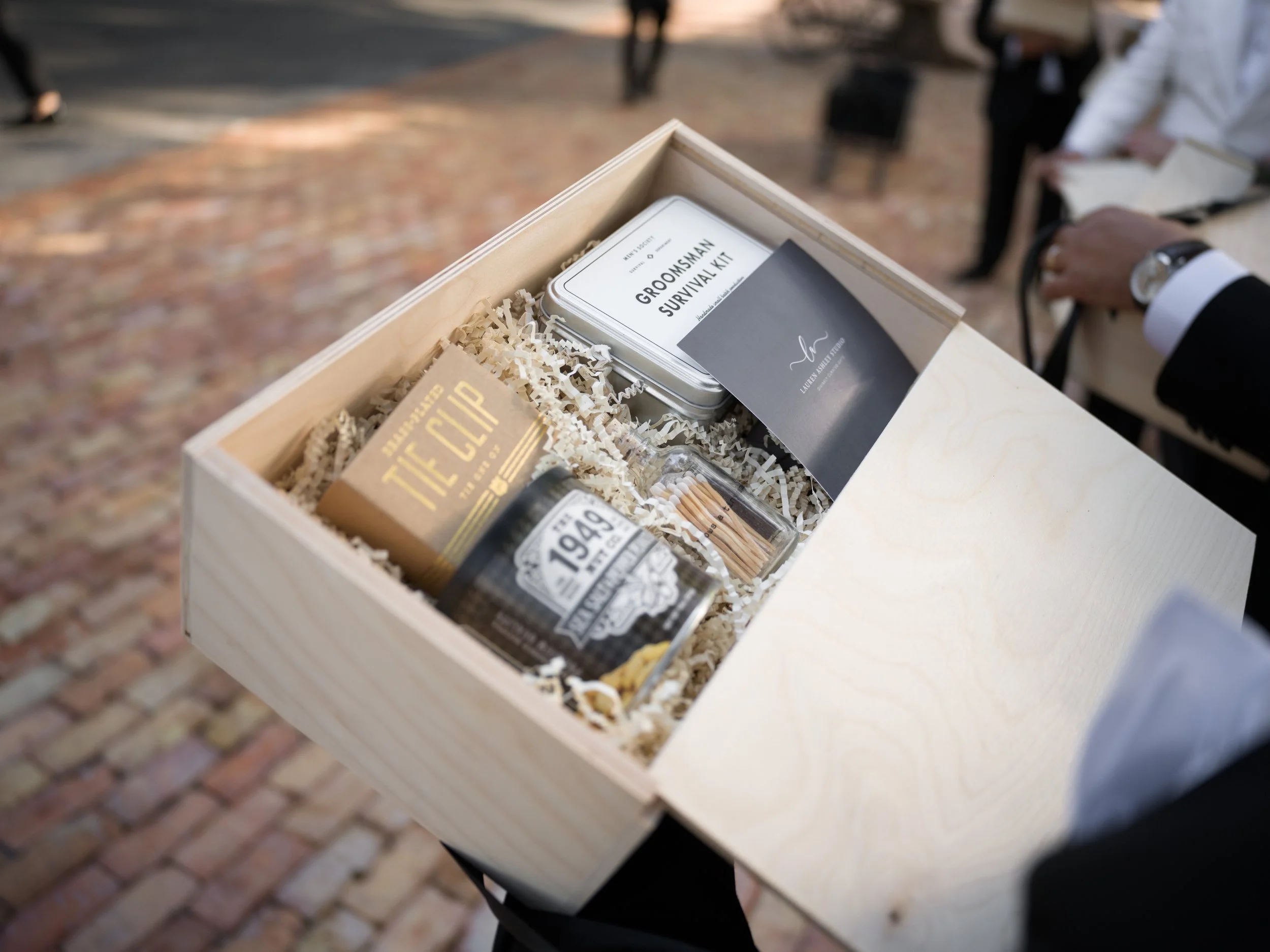 Close-up of custom groomsmen gift box with personalized accessories
