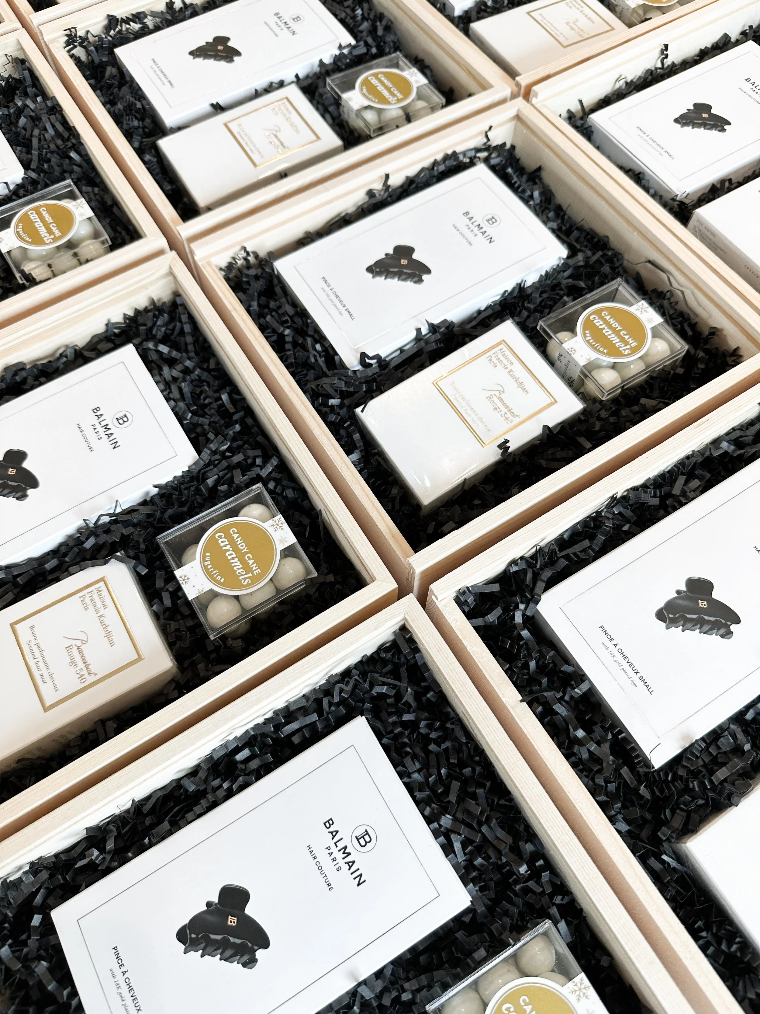 ⁠Collection of bespoke wooden corporate gift boxes filled with premium luxury items, designed for VIP client appreciation and executive events in Miami.