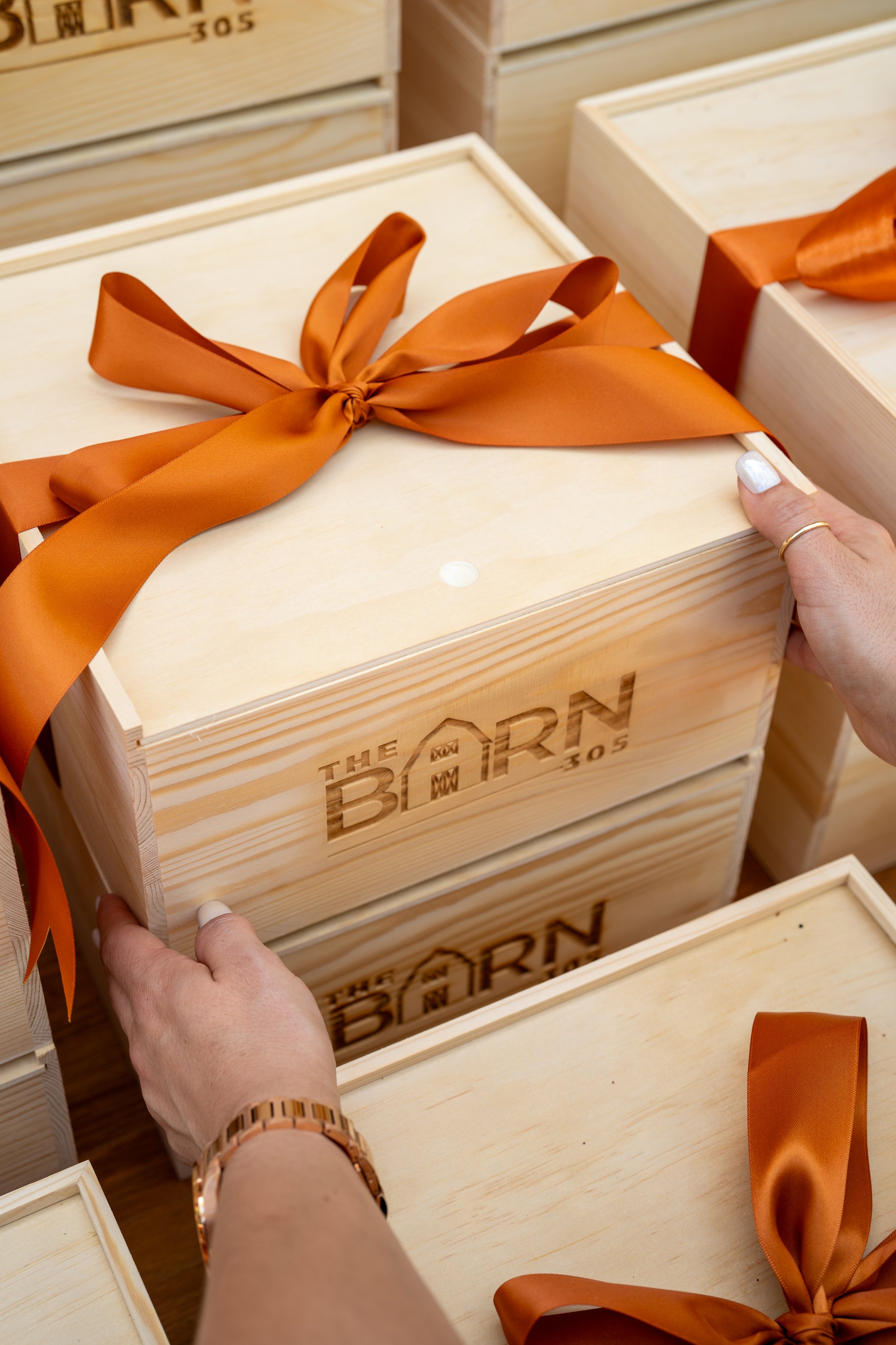 Luxury custom gift box curation with branded wooden gift box and orange ribbon by Lauren Ashley Studio