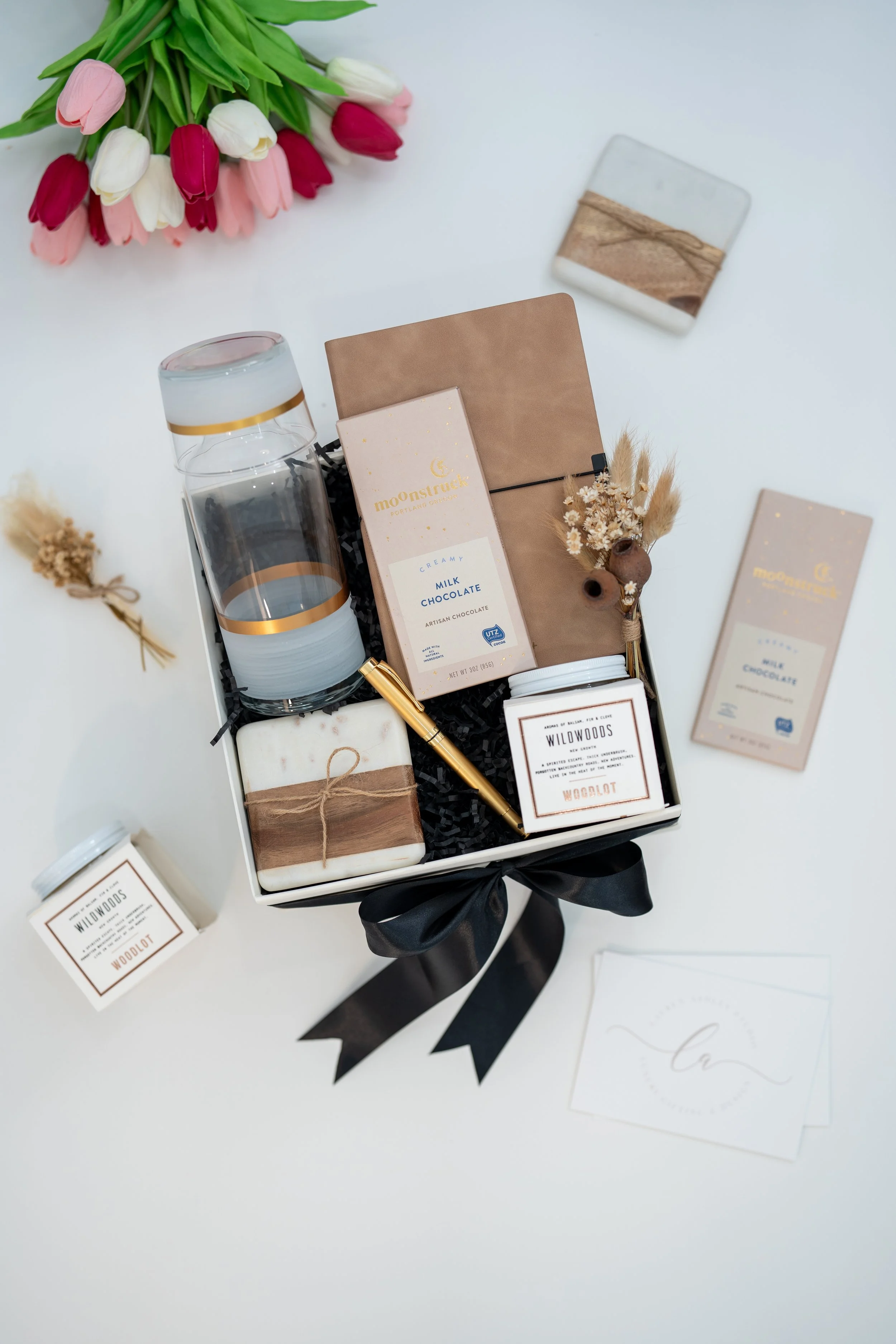 Real estate and law firm corporate gift box with notebook, candle, chocolate, soap, and glass bottle by Lauren Ashley Studio