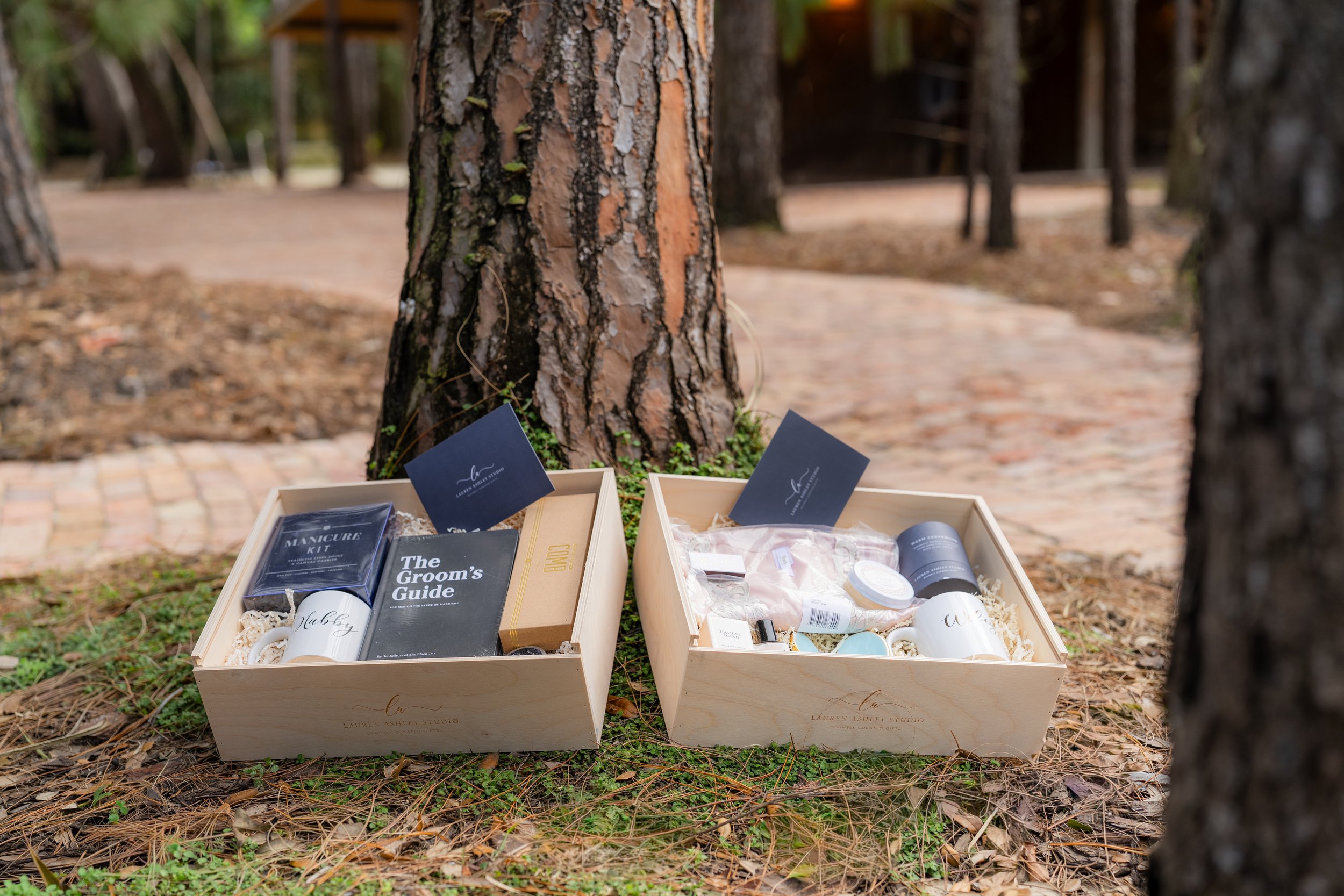 Luxury wedding welcome gift boxes for bridesmaids and groomsmen set up outdoors at a Miami wedding venue