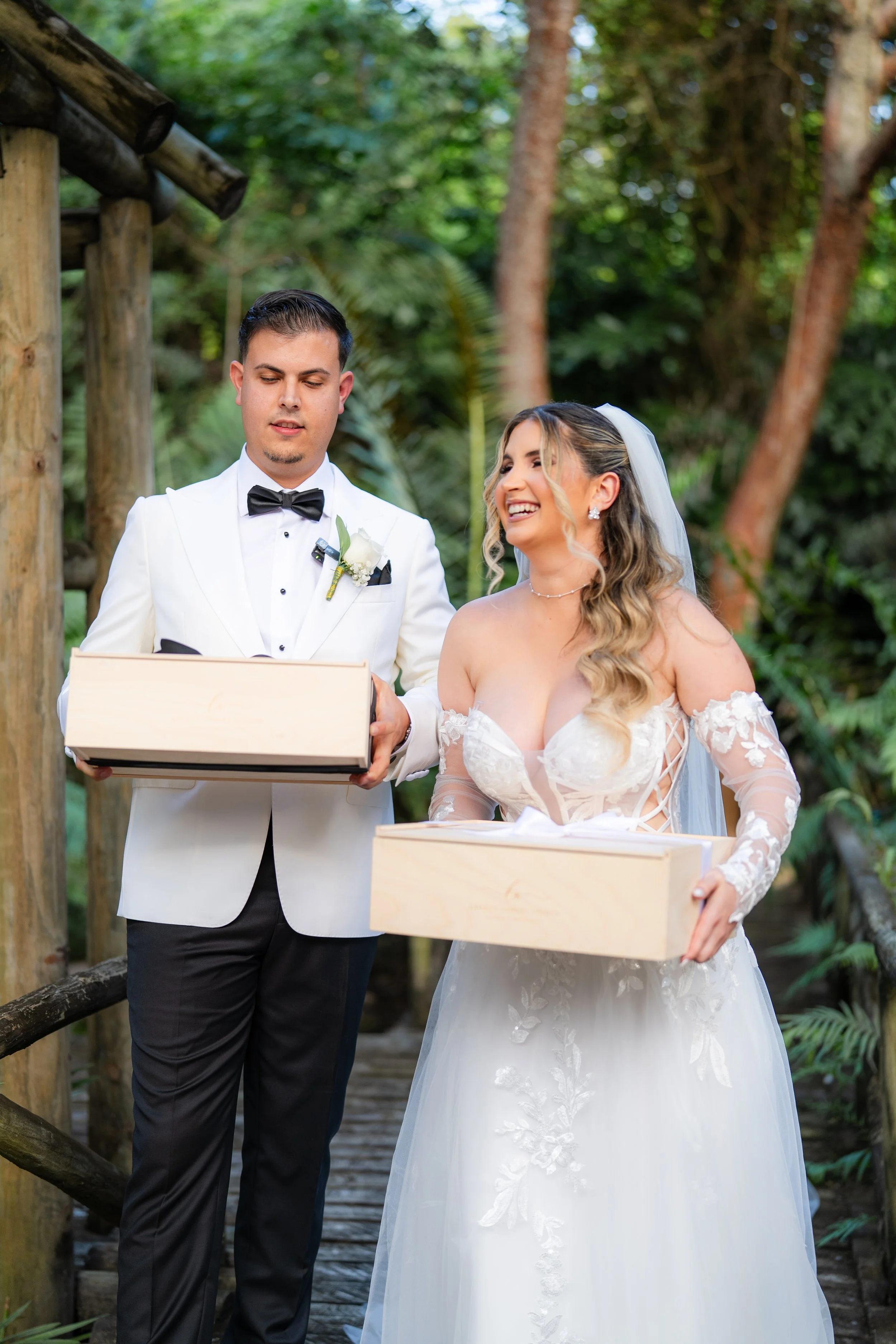 Bride and groom holding luxury wedding gift boxes by Lauren Ashley Studio