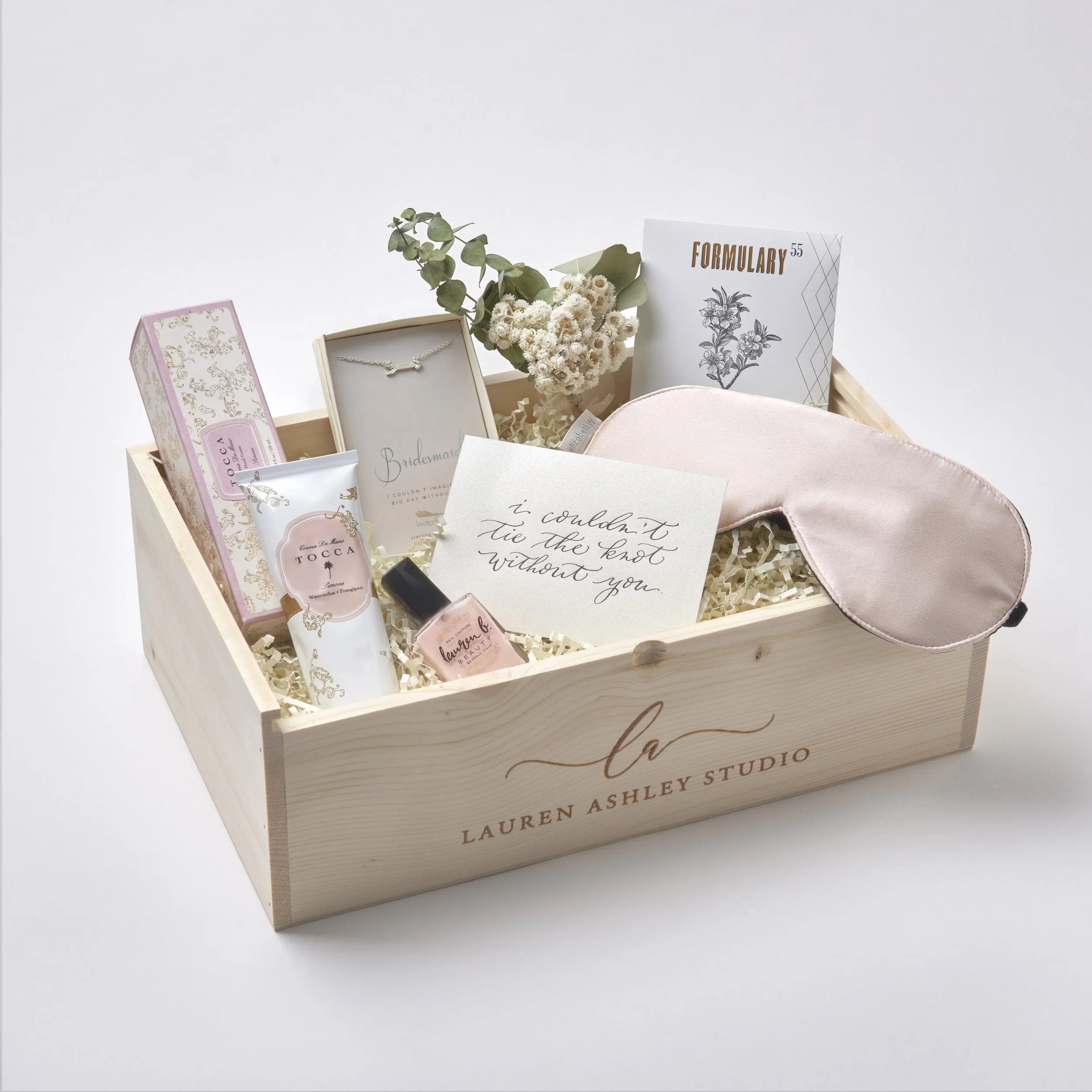 Close-up of personalized bridesmaid proposal gift box with silk robe and custom details