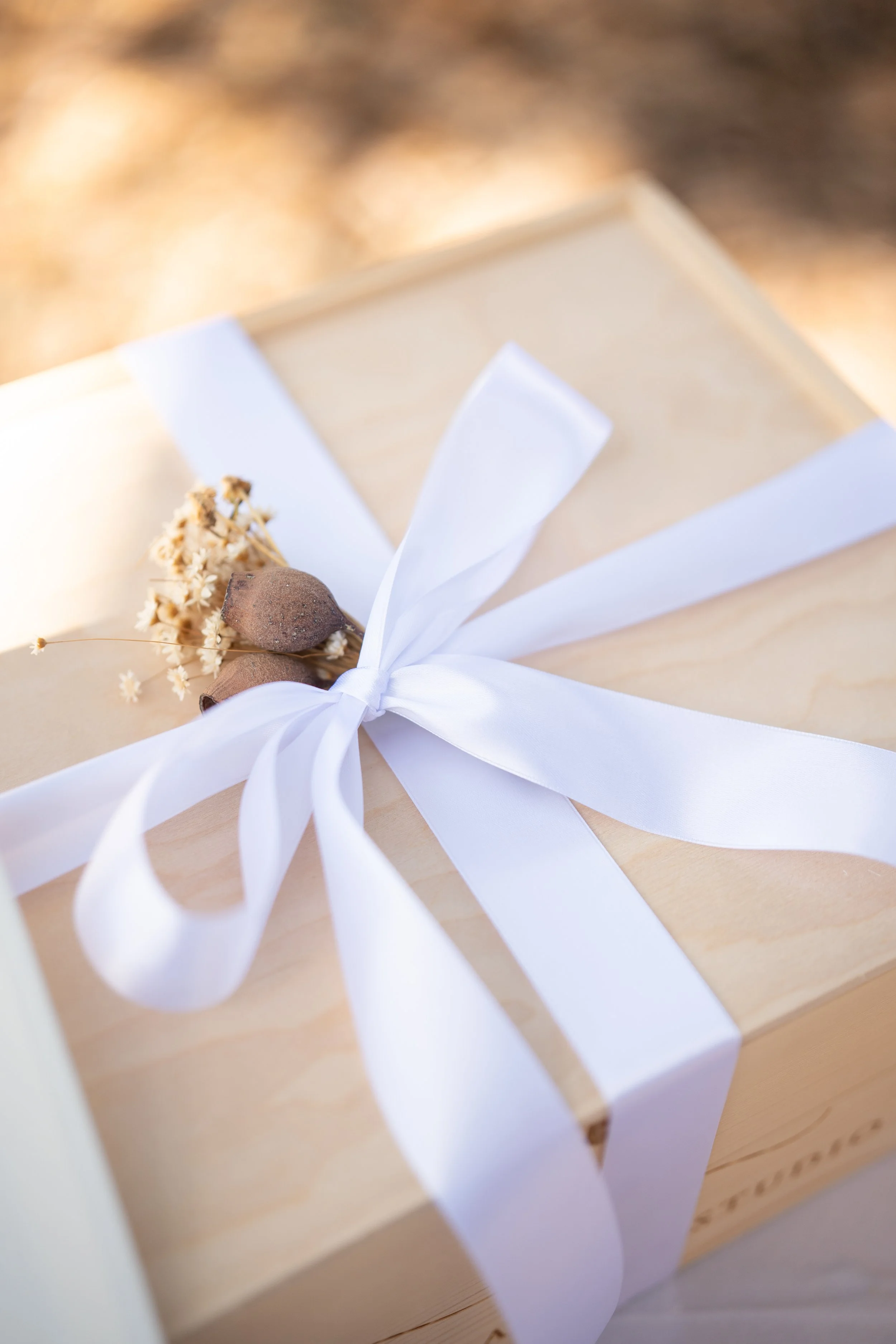 Wooden wedding welcome gift box detail with ribbon by Lauren Ashley Studio in Miami