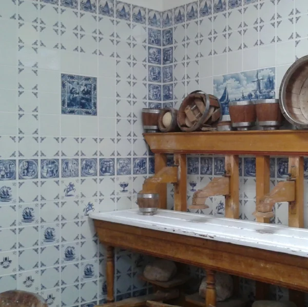 Delftware tiles tell stories of traditional farm labors and crafts.