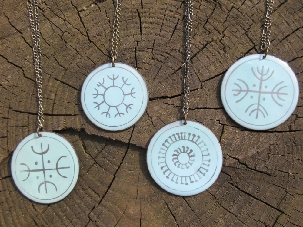 Enameled copper pendants derive meaning from symbols of solar worship, like fireworks in July.