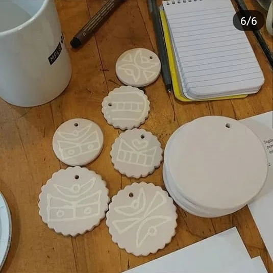 Talismans ready for Raku firing, designs based around geographical features around home.
