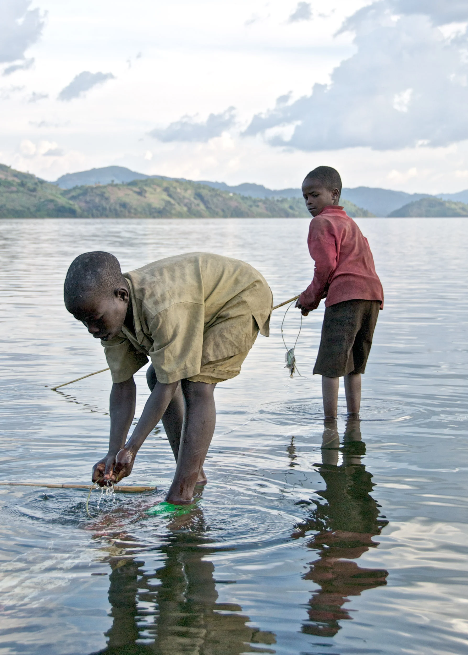  Boys catch  sambaza  sardines as their fathers row back from a day of fishing on Lake Burera, in the north.&nbsp; 