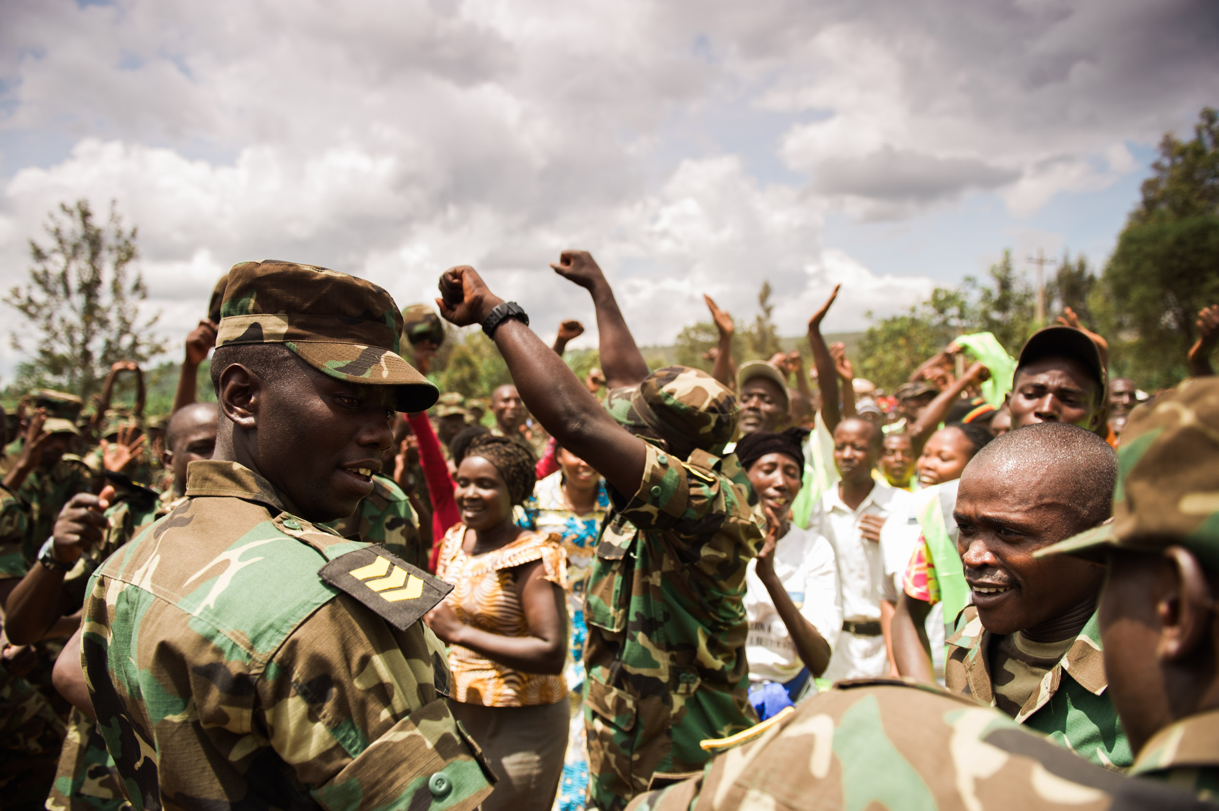  Dancing among soldiers and citizens during Umuganda, a national day of community work. 