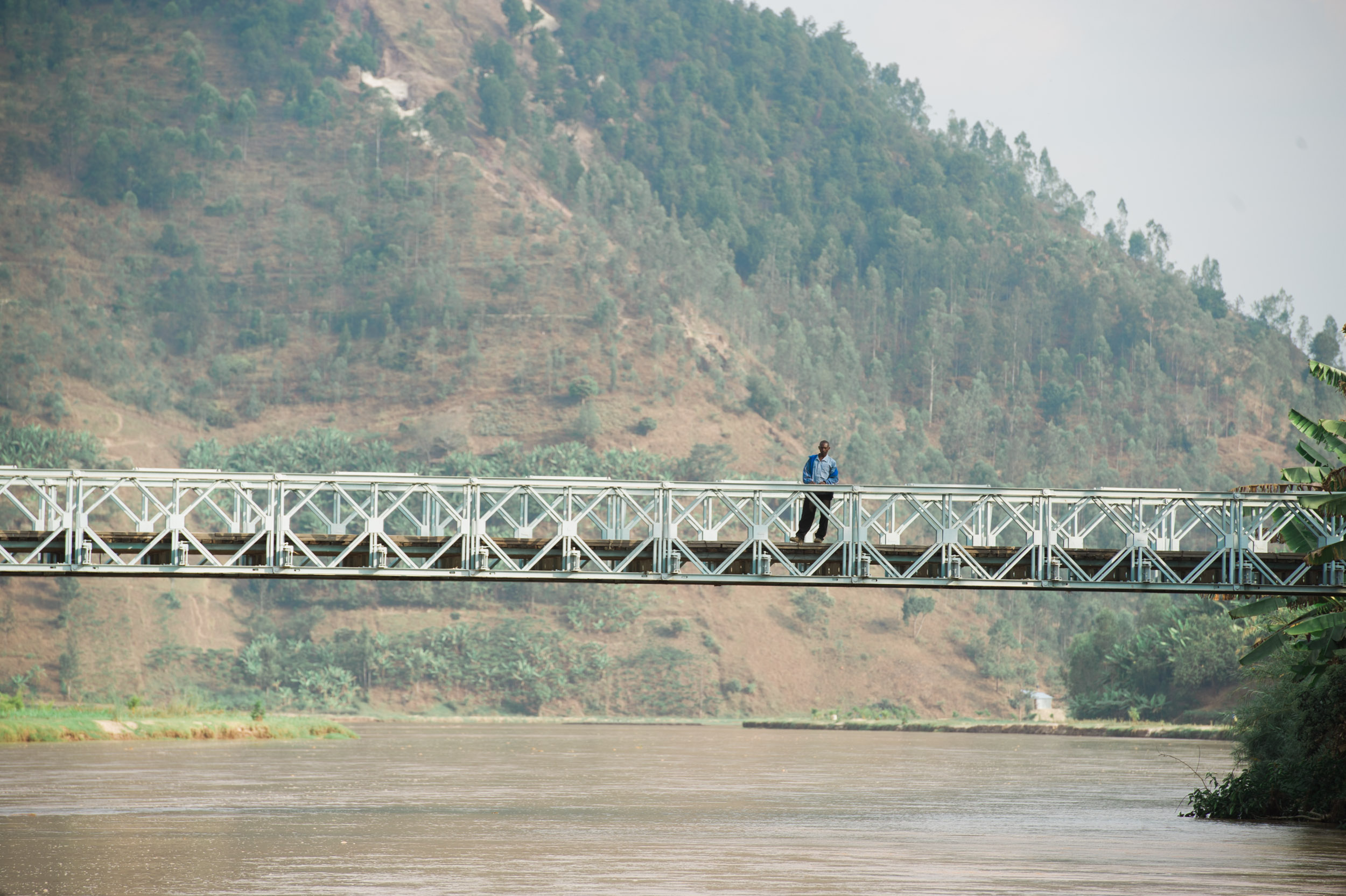  A man stands on a bridge that crosses the Nyabarongo River in northern Rwanda.&nbsp; 