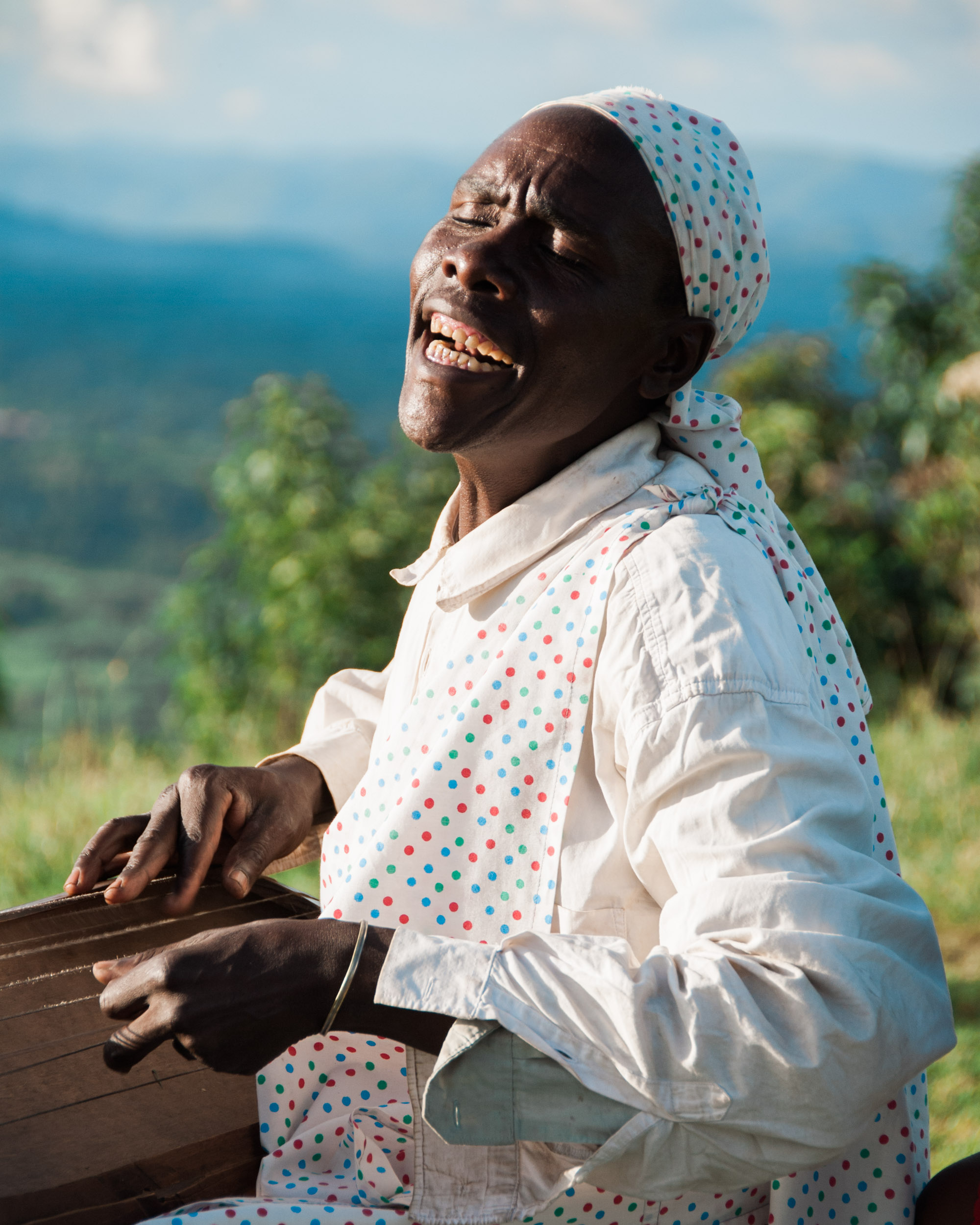  A musician plays traditional folk music with his  inganga,&nbsp; high on a ridge between the two "twin lakes" of Ruhondo and Burera. 