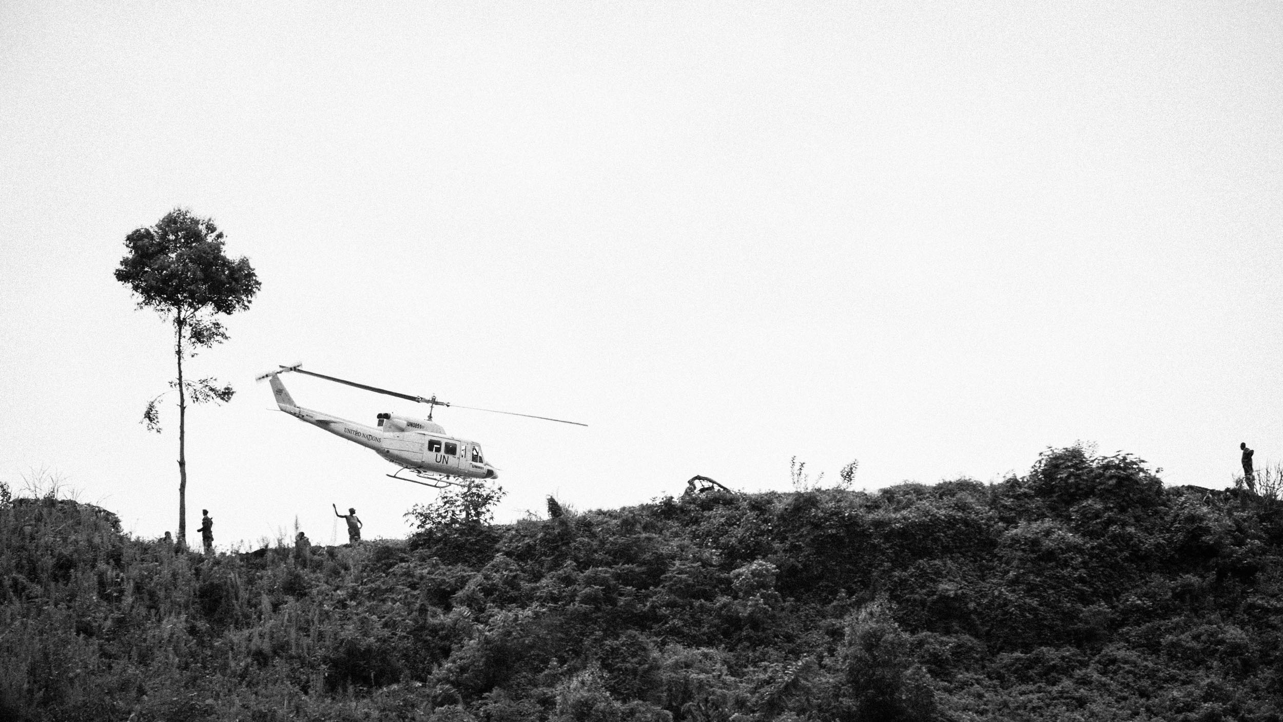  A UN helicopter passes overhead a group of M23 rebels occupying a hill near Goma, eastern DRC. 