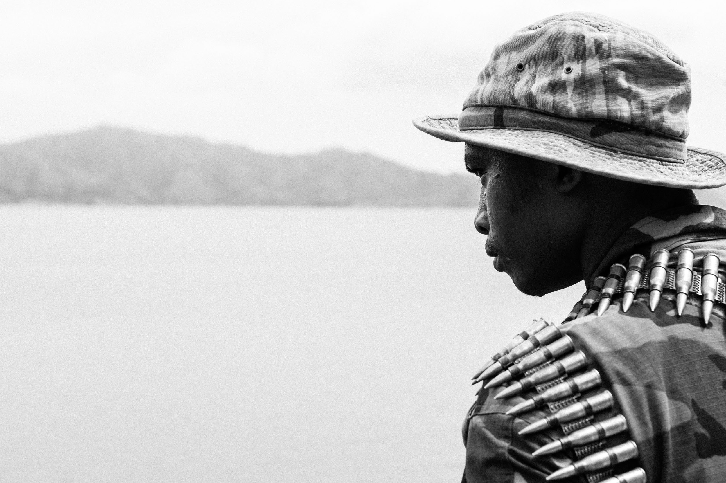  An M23 rebel looks out over Lake Kivu near Goma, DRC. 