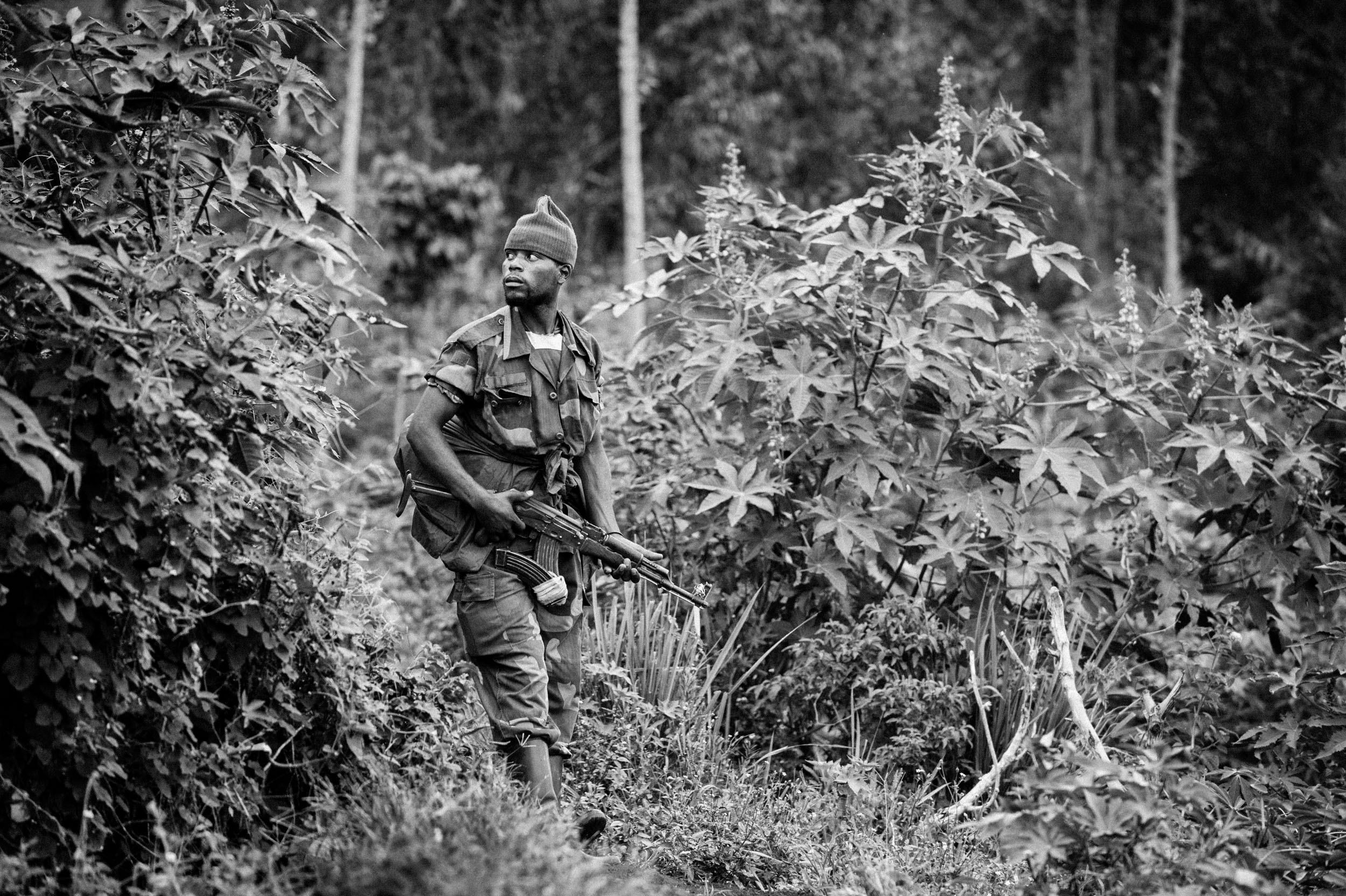  A Mai-Mai rebel 10 kilometers south of the M23 rebels’ position on Lake Kivu. The Mai-Mai guerrilla group is known for sticking tree branches in AK-47 barrels to give them invincibility in war. 